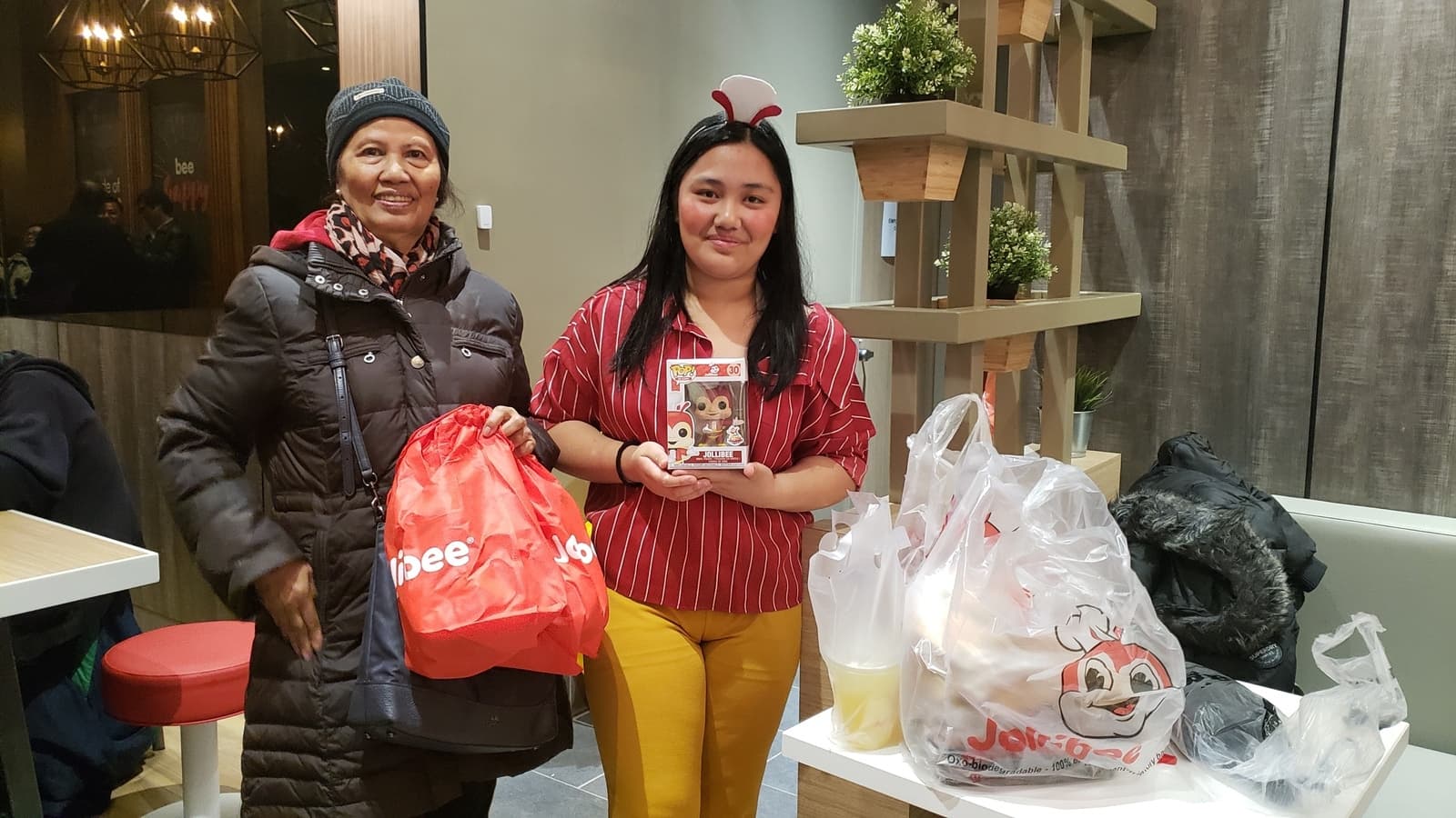 A young woman poses with her aunt at Jollibee in NYC