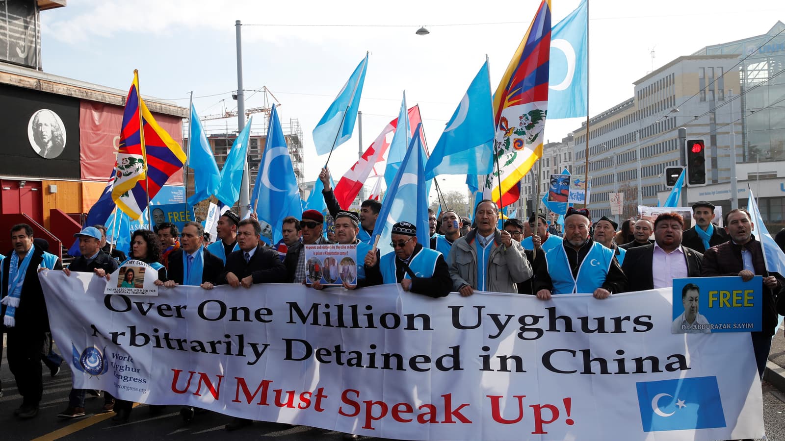 A group of protestors demonstrate with signs.