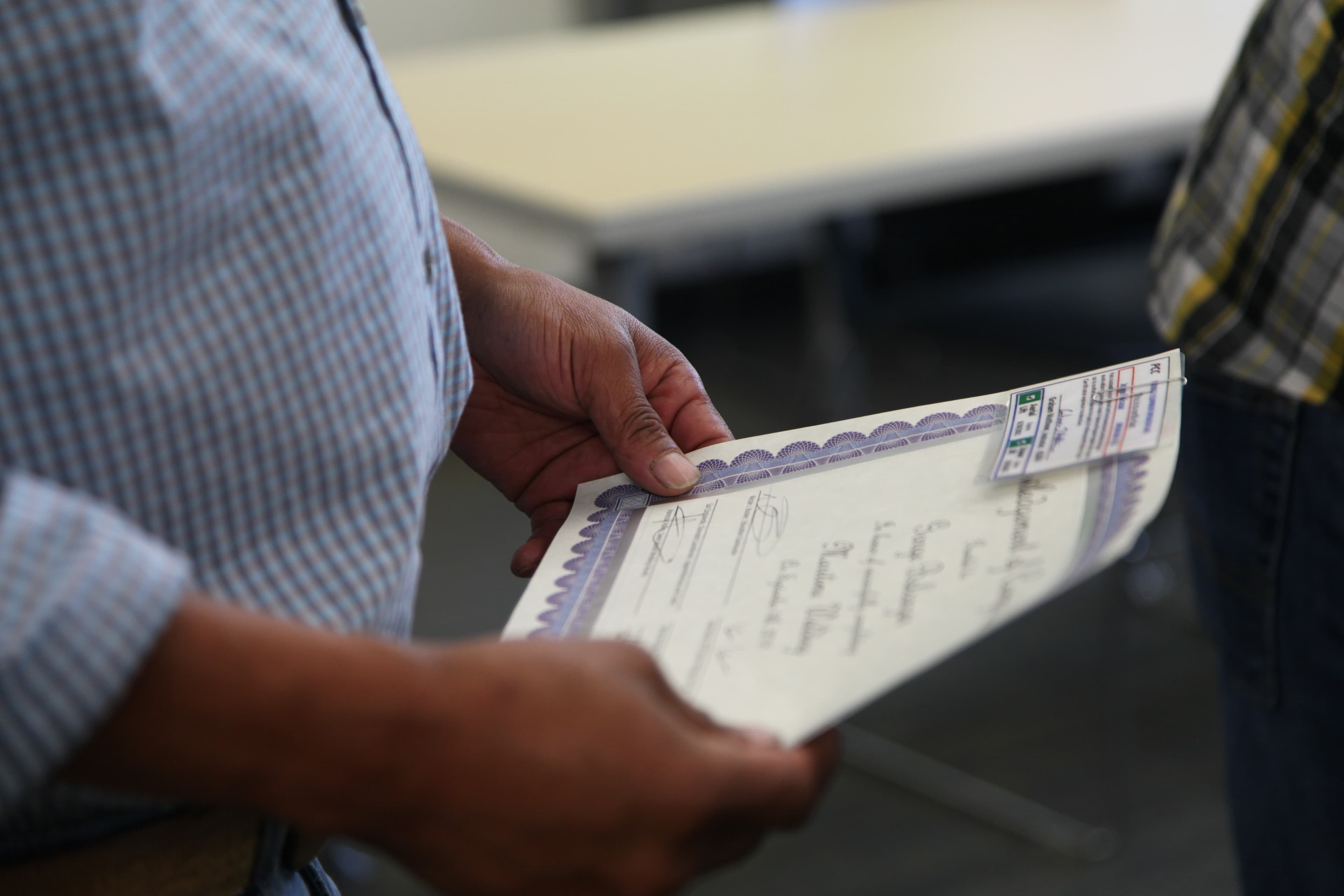 Hands holding a certificate