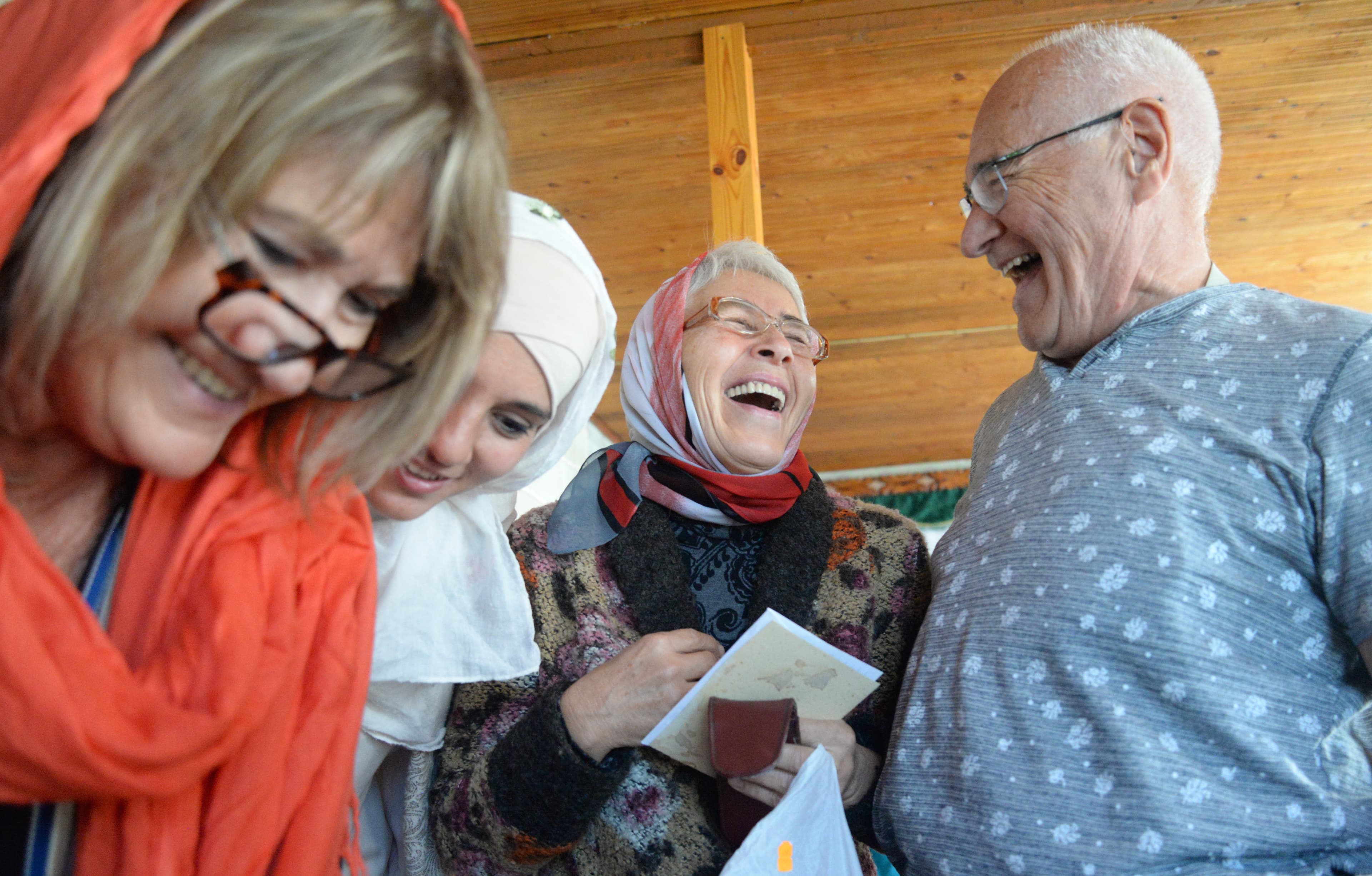 People standing near each other, laughing