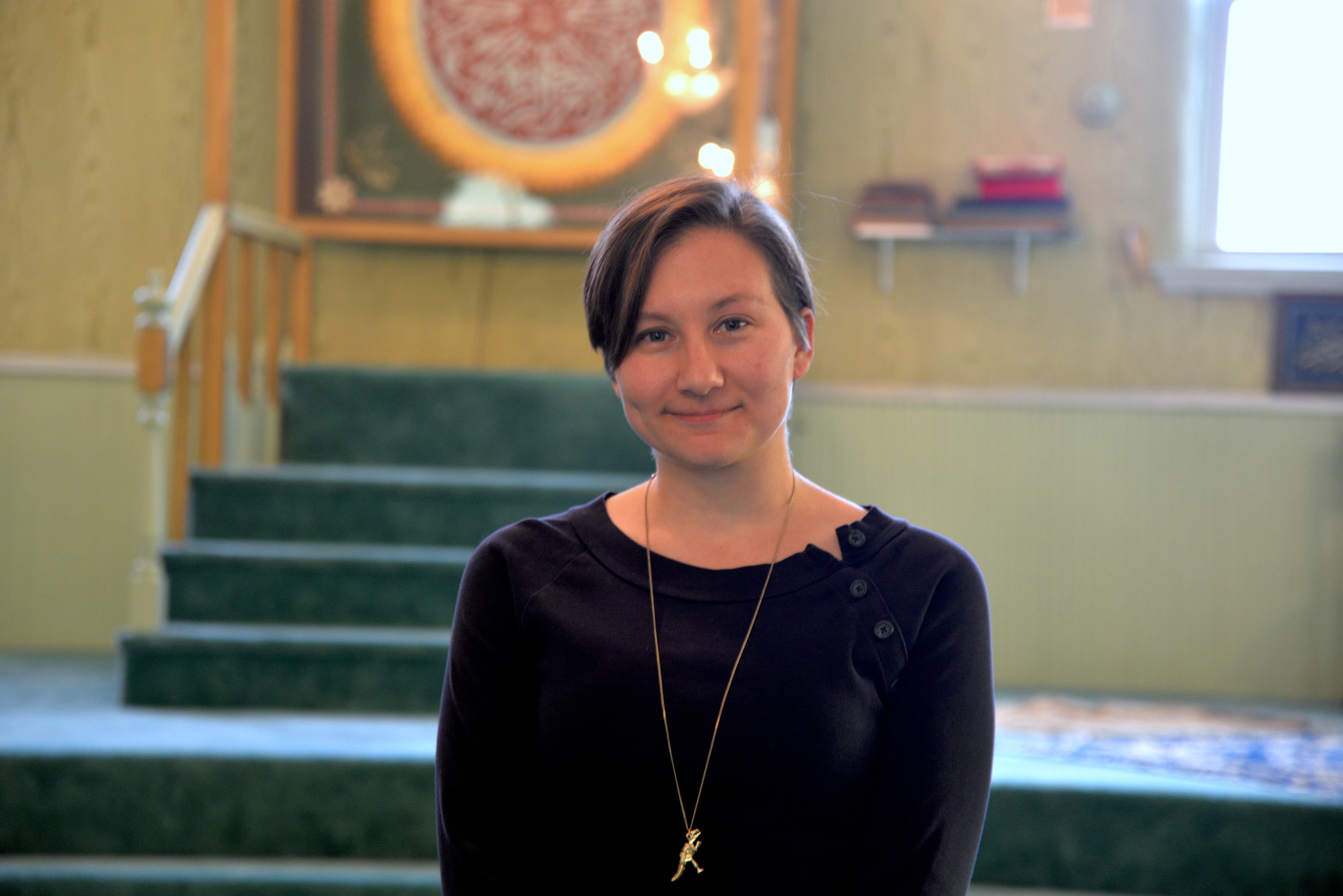 Woman at front of room in mosque