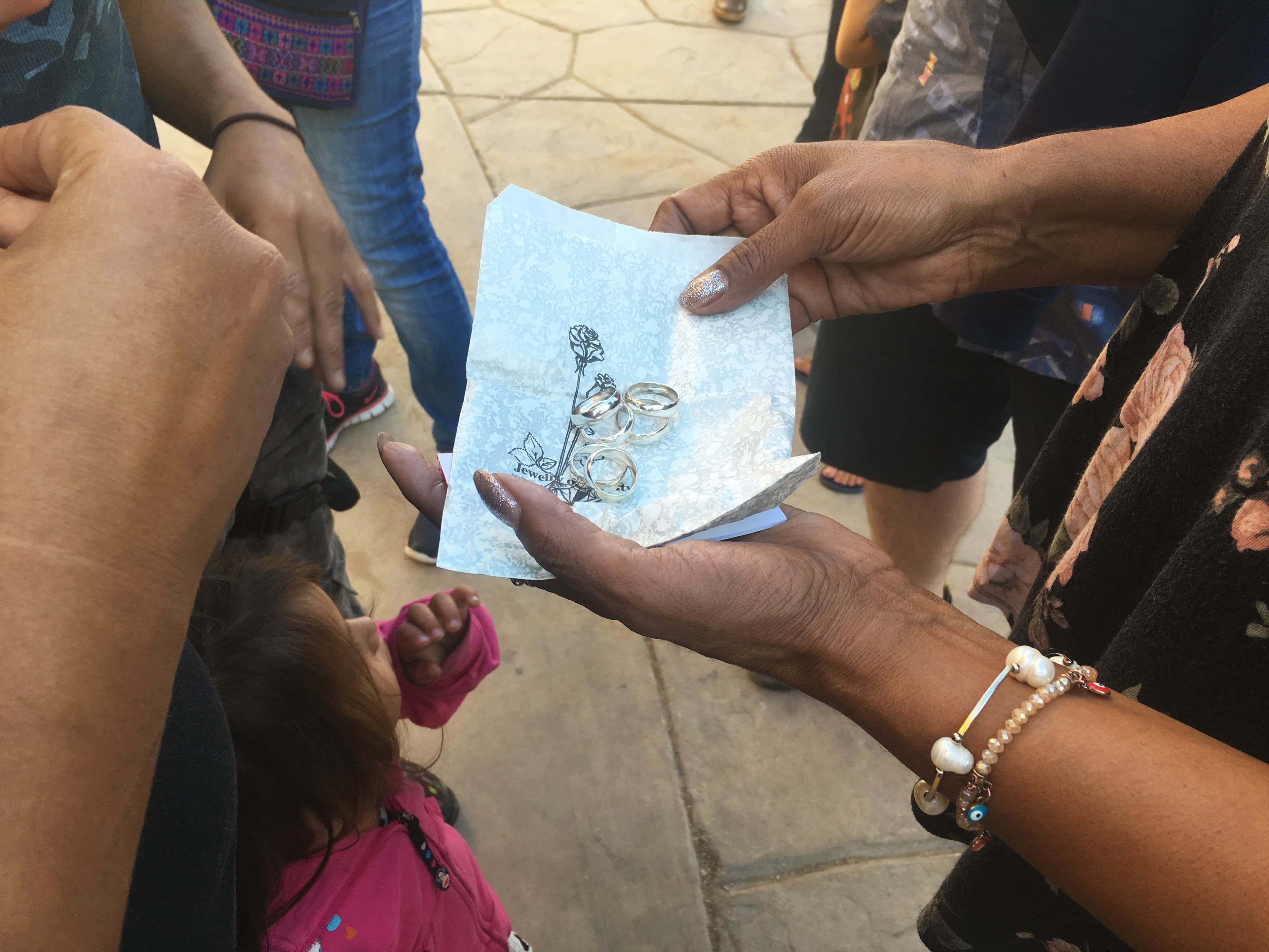 several silver rings in the palm of a volunteer