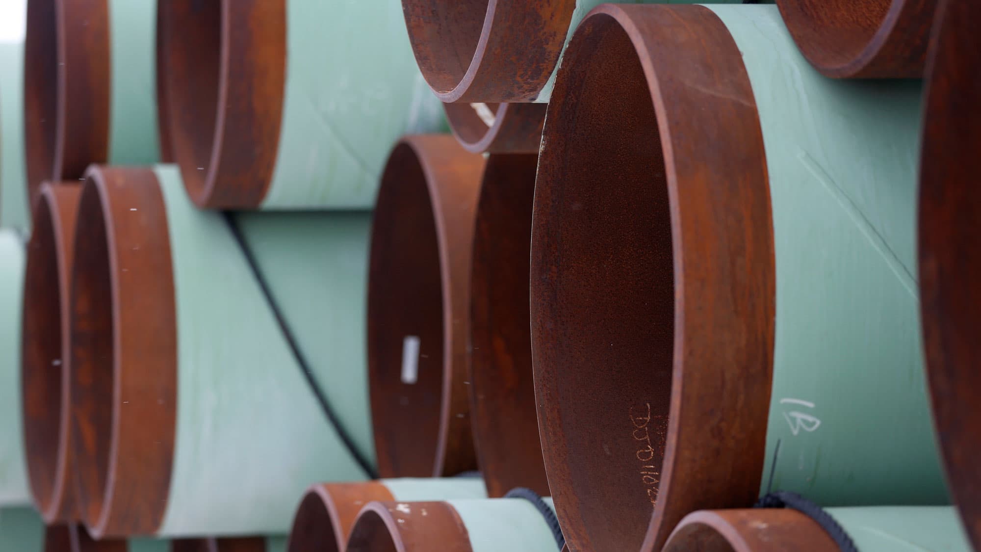 Copper and blue colored pipes are shown stacked on their sides in Gascoyne, North Dakota.