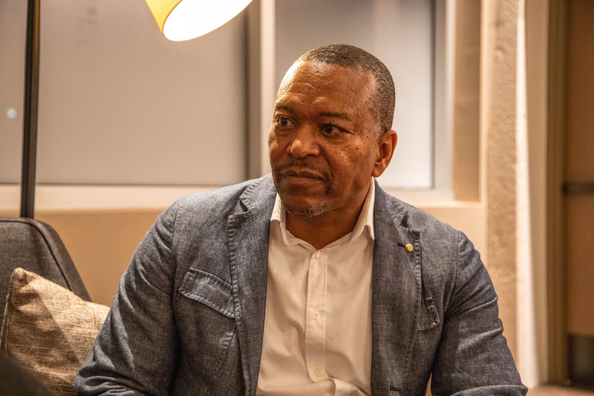 Leo Smith is shown wearing a blazer looking to his right.