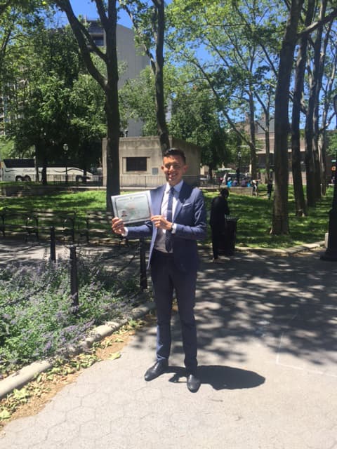 Man posing with certificate