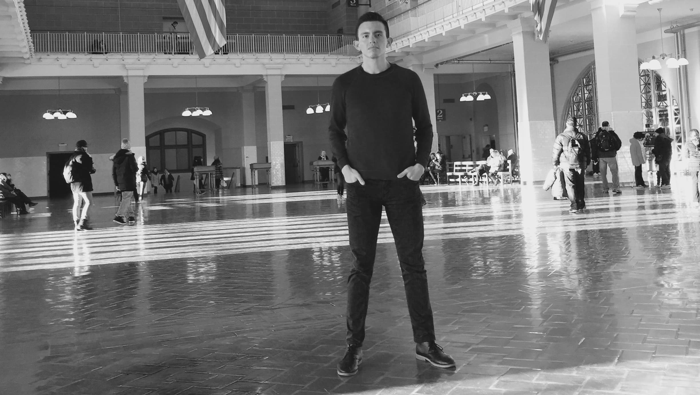 Black and white photo of man standing in room