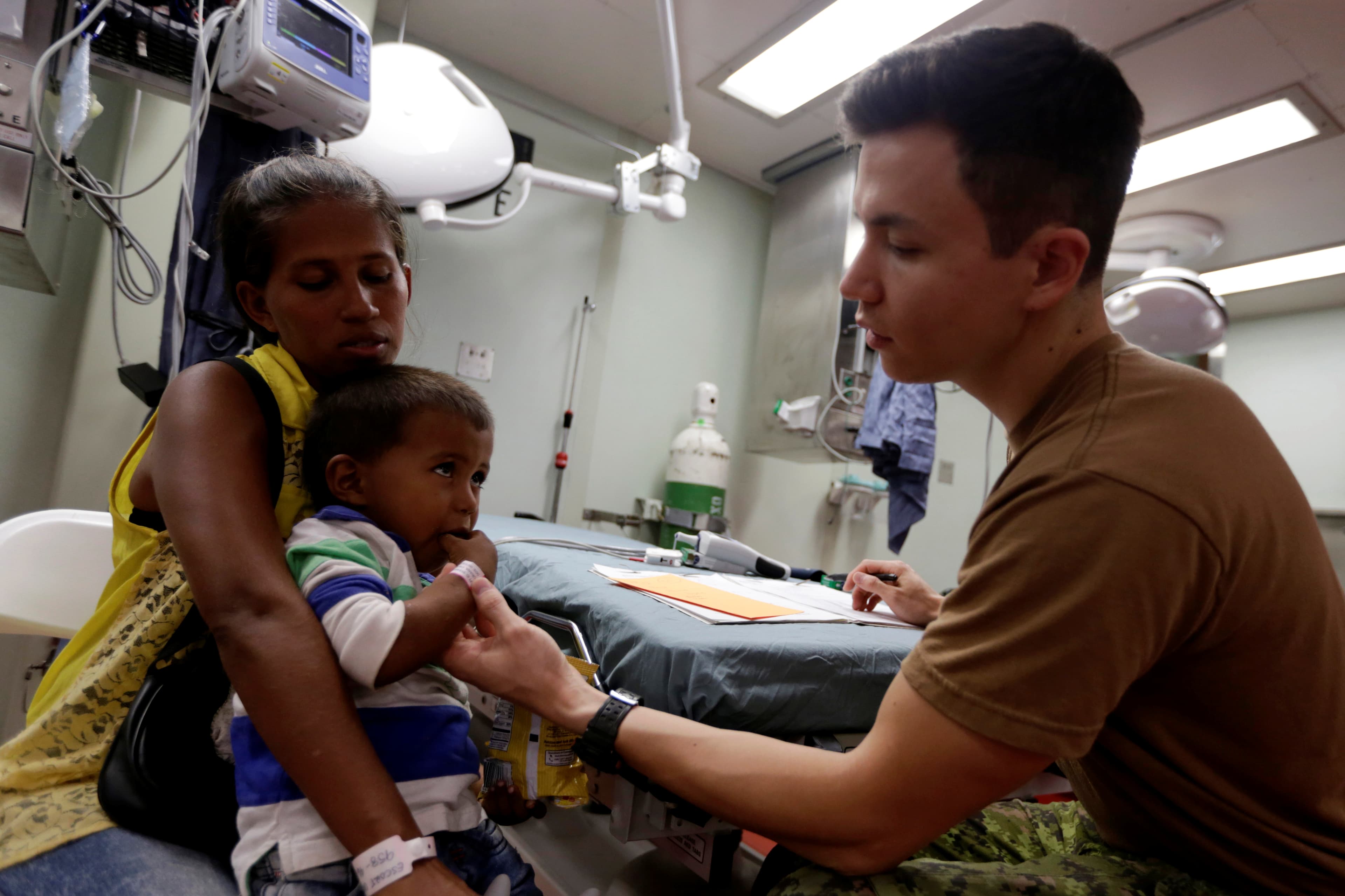 a young child in a woman's arms