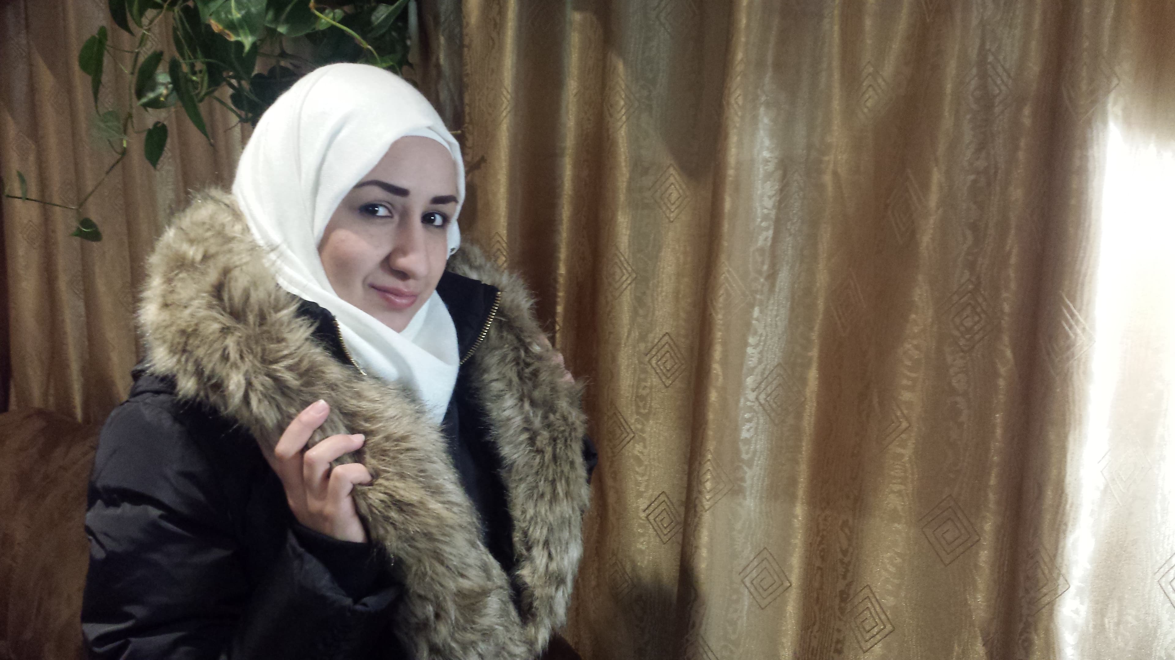 Khuloud Baranbo with her new winter coat, bought at a Black Friday sale. Her family counts their pennies to make ends meet in Canada.