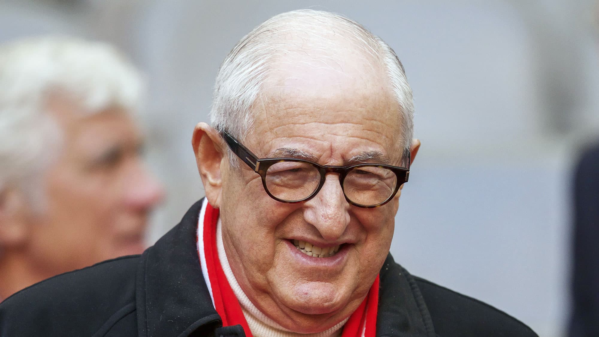 a closeup of an older man with a bald head and glasses