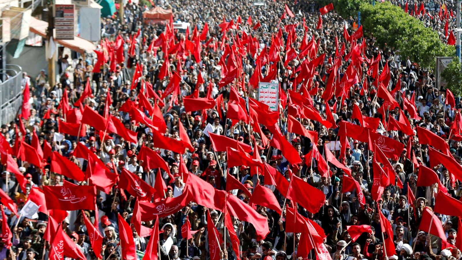 A sea of red flags wave as Yemeni Houthi protest.