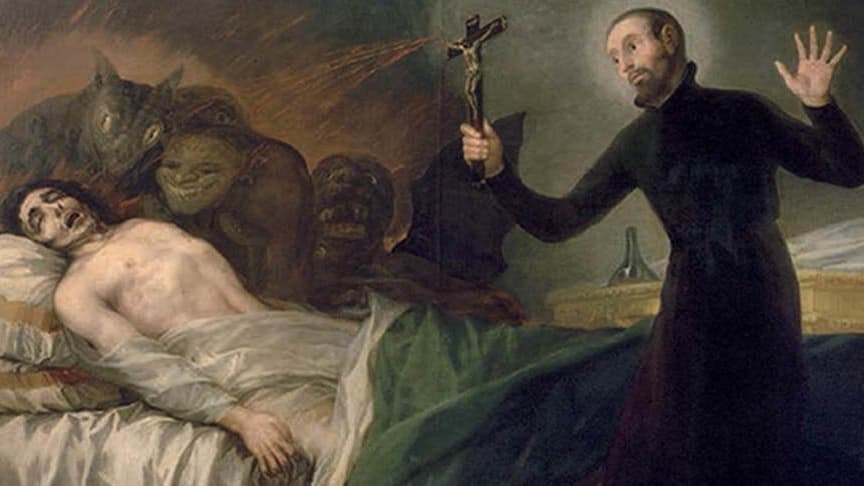 A priest stands over a pale white body on a bed surrounded by demon heads.