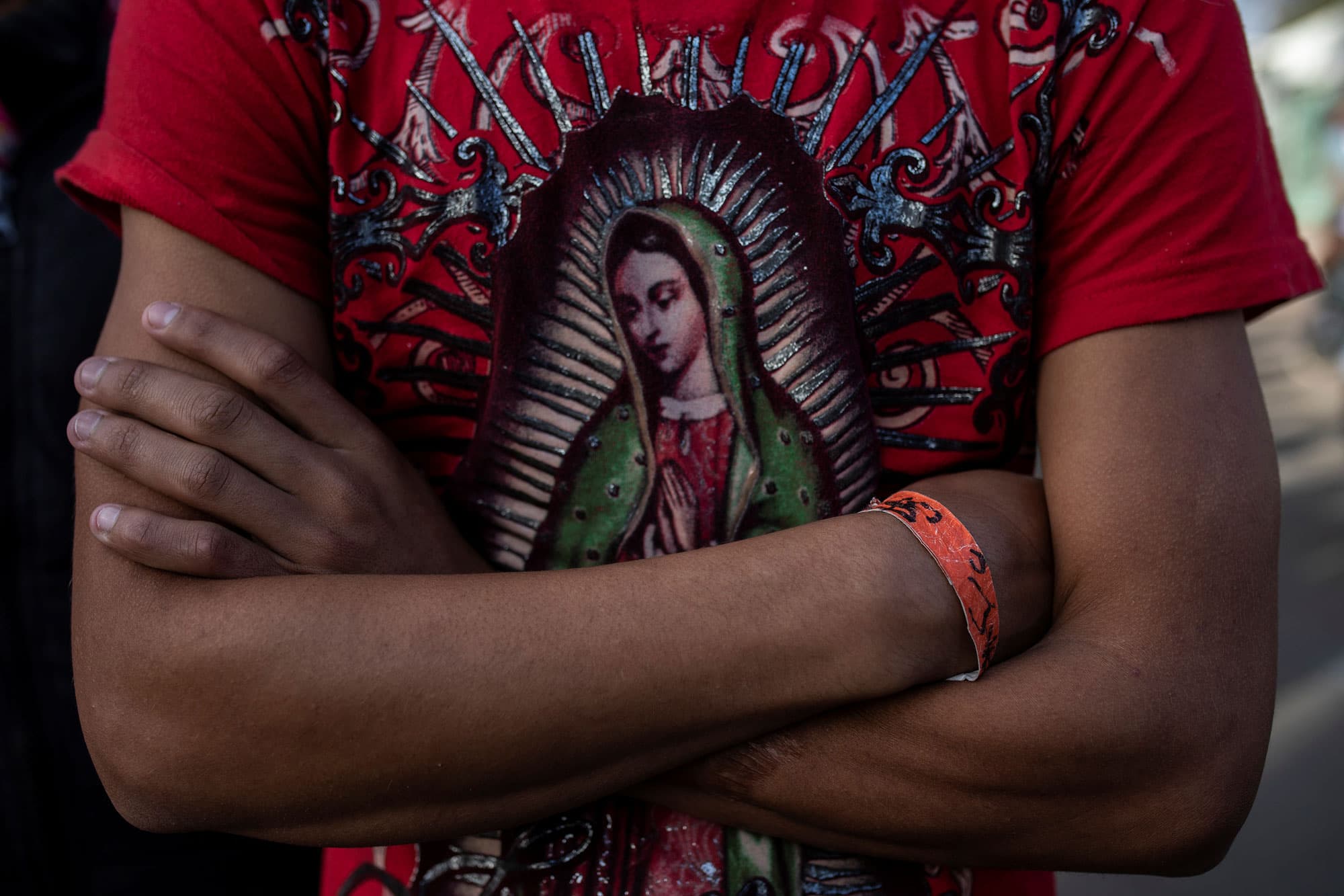Herso is shown wearing a red t-shirt depicting the Virgin of Guadalupe.