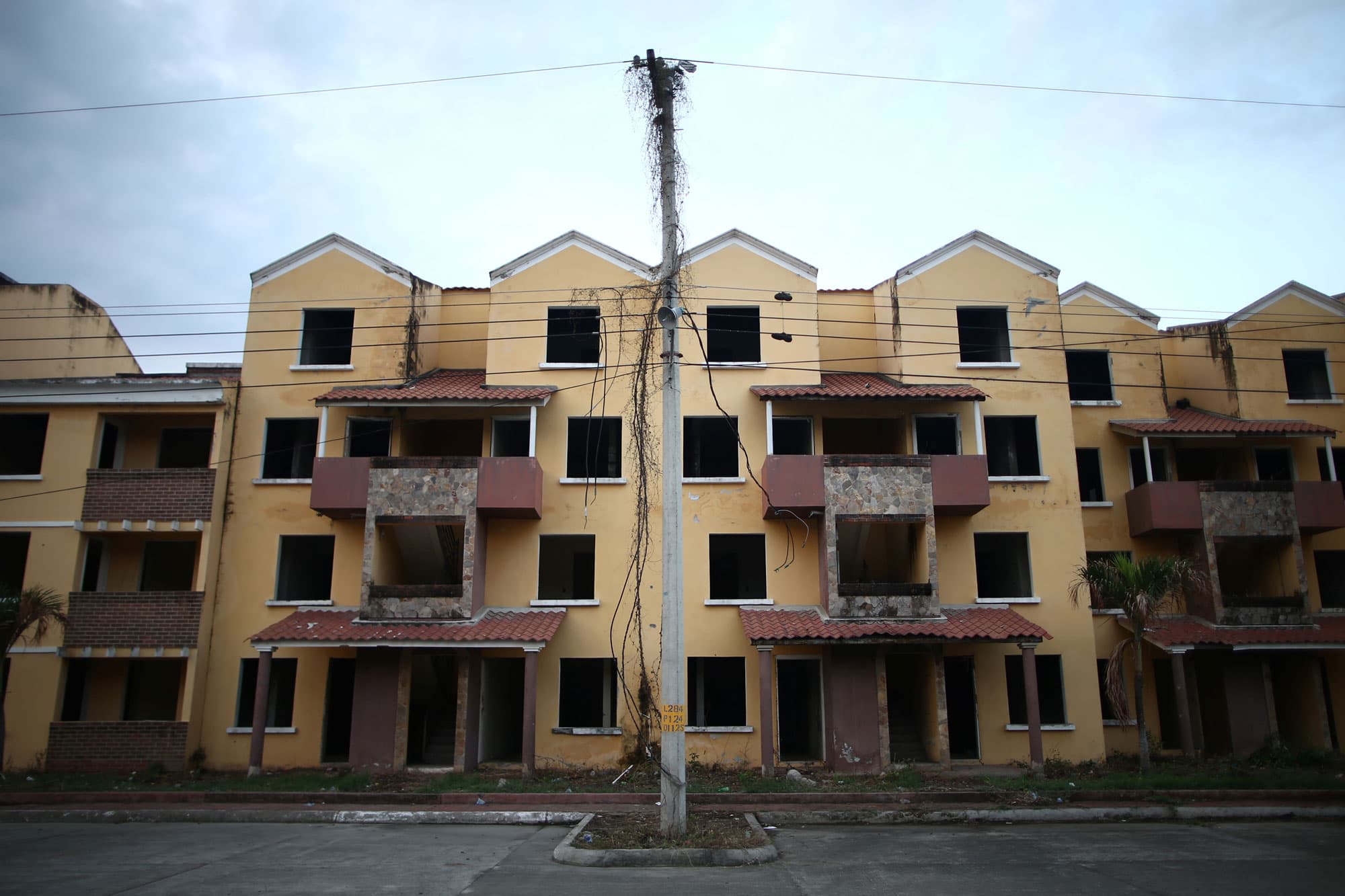The facade of a building without windows or doors, occupied by Barrio-18, is seen in San Pedro Sula, Honduras.