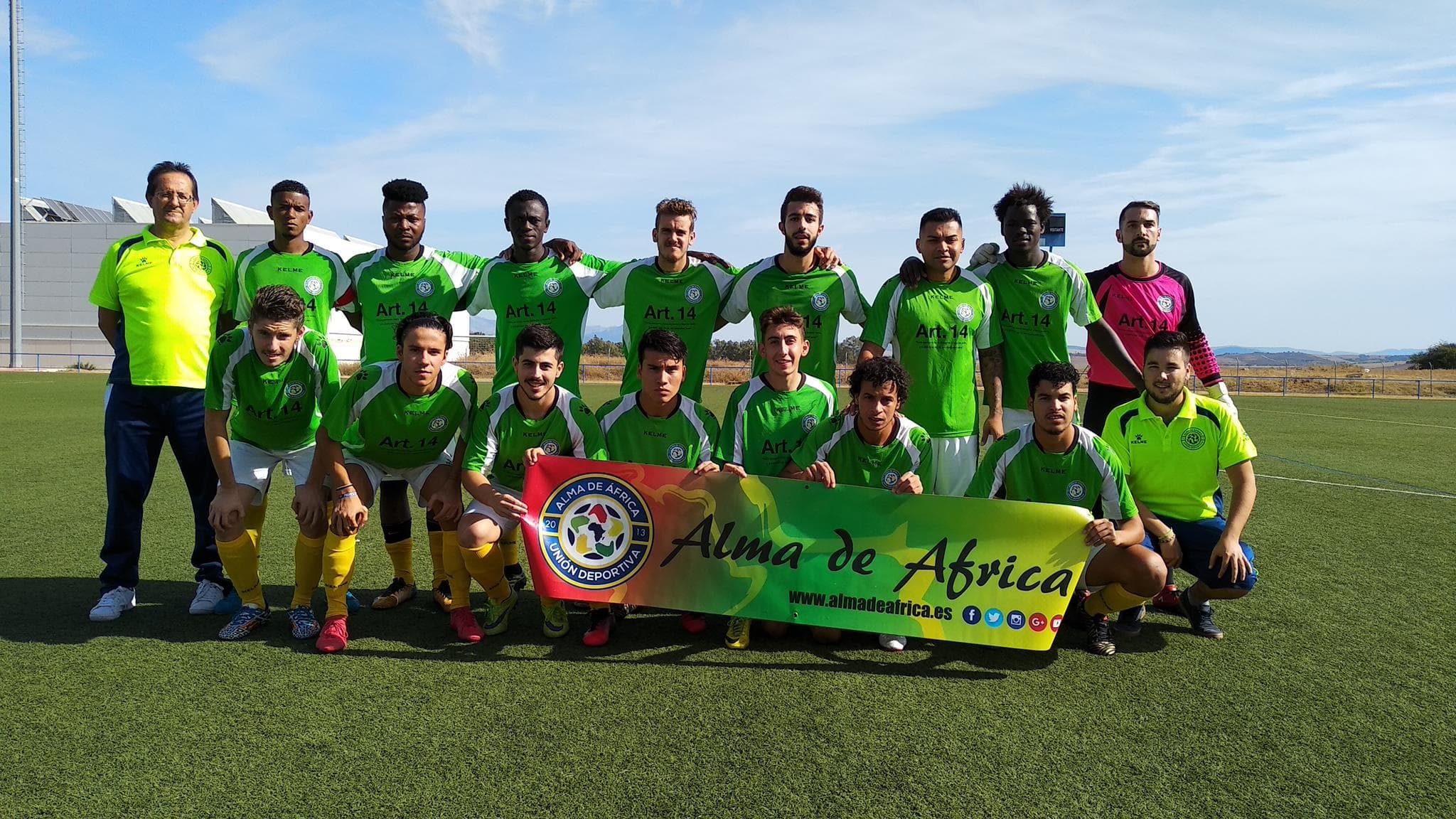 A group of men wearing yellow and green jerseys pose for a team photo.