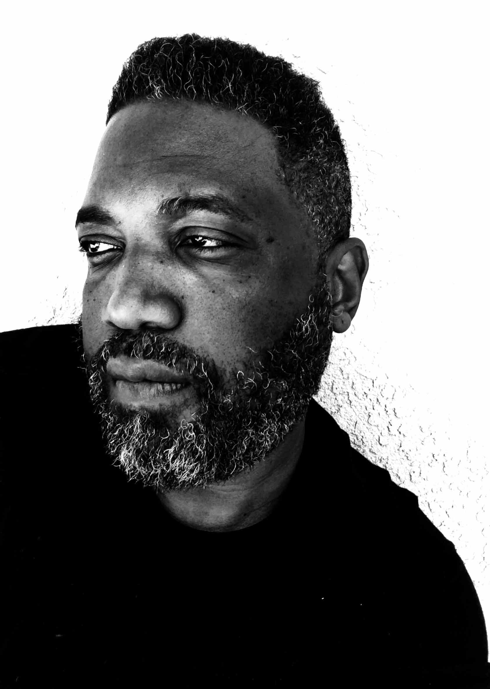 A man poses in a headshot photo