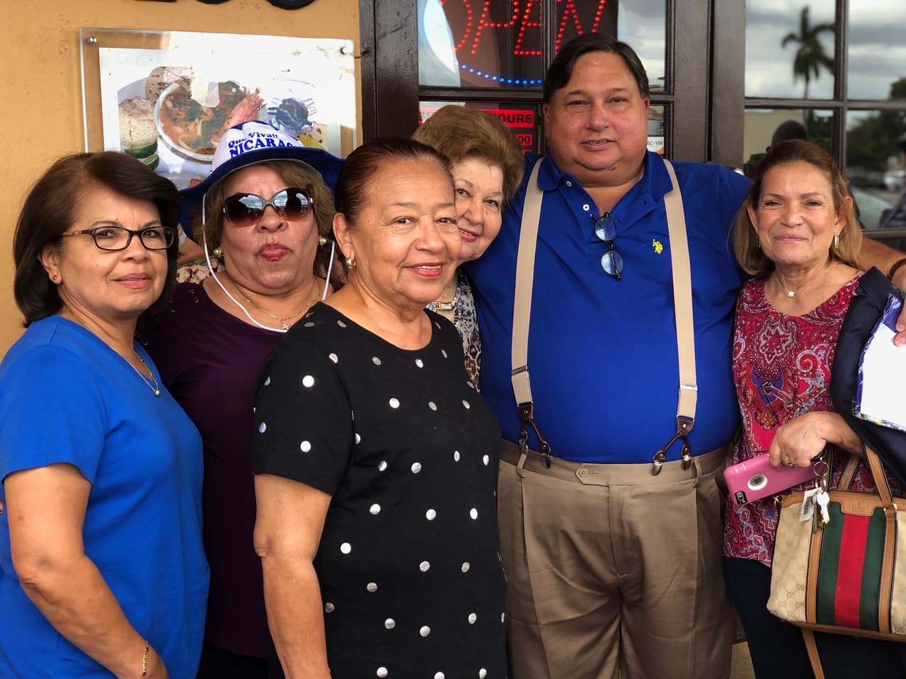 Jaime Arellano is a large man in a suit who stands on the righthand side of the frame
