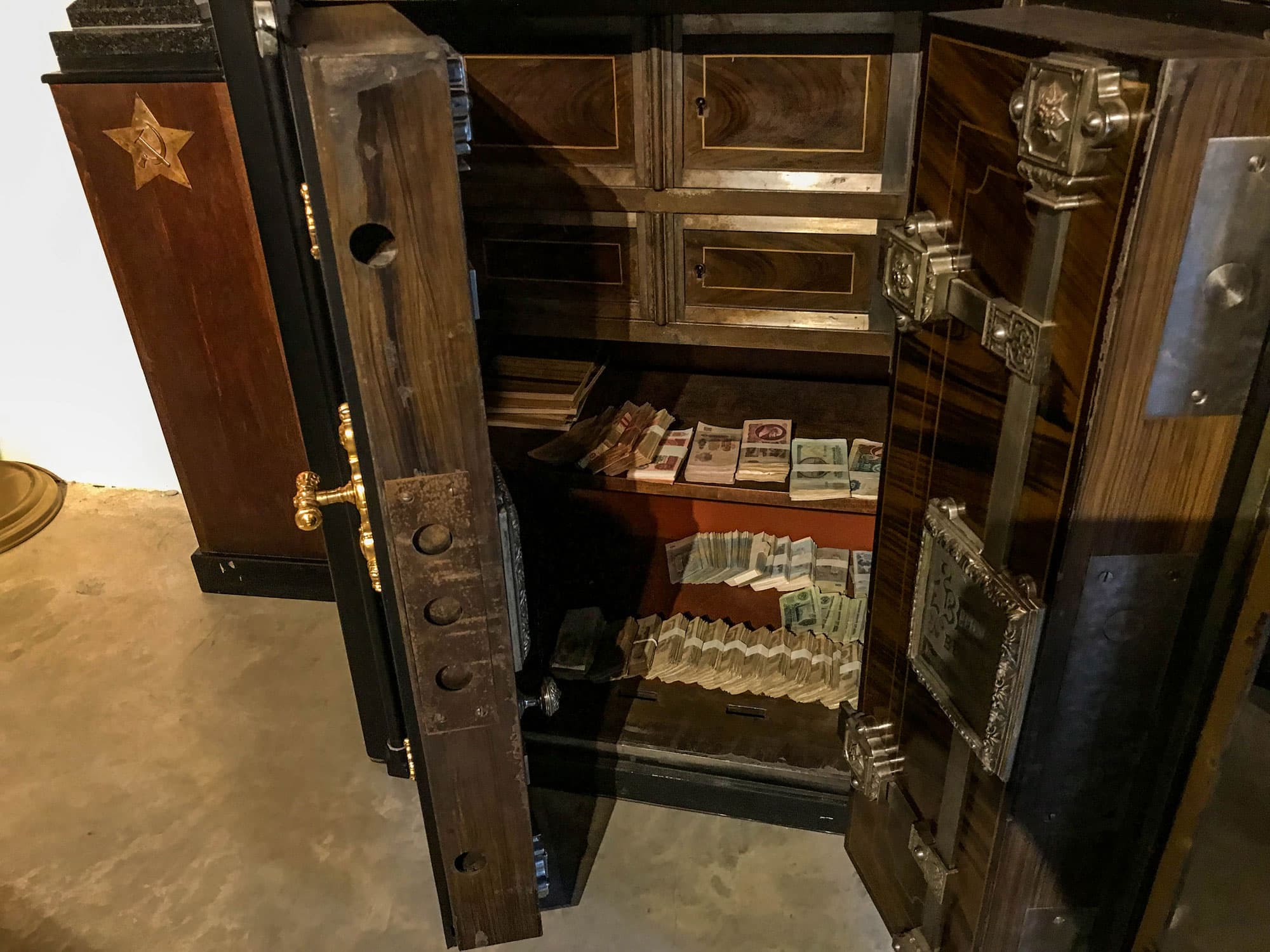 A safe is shown filed with 140,000 in Soviet-era rubles.