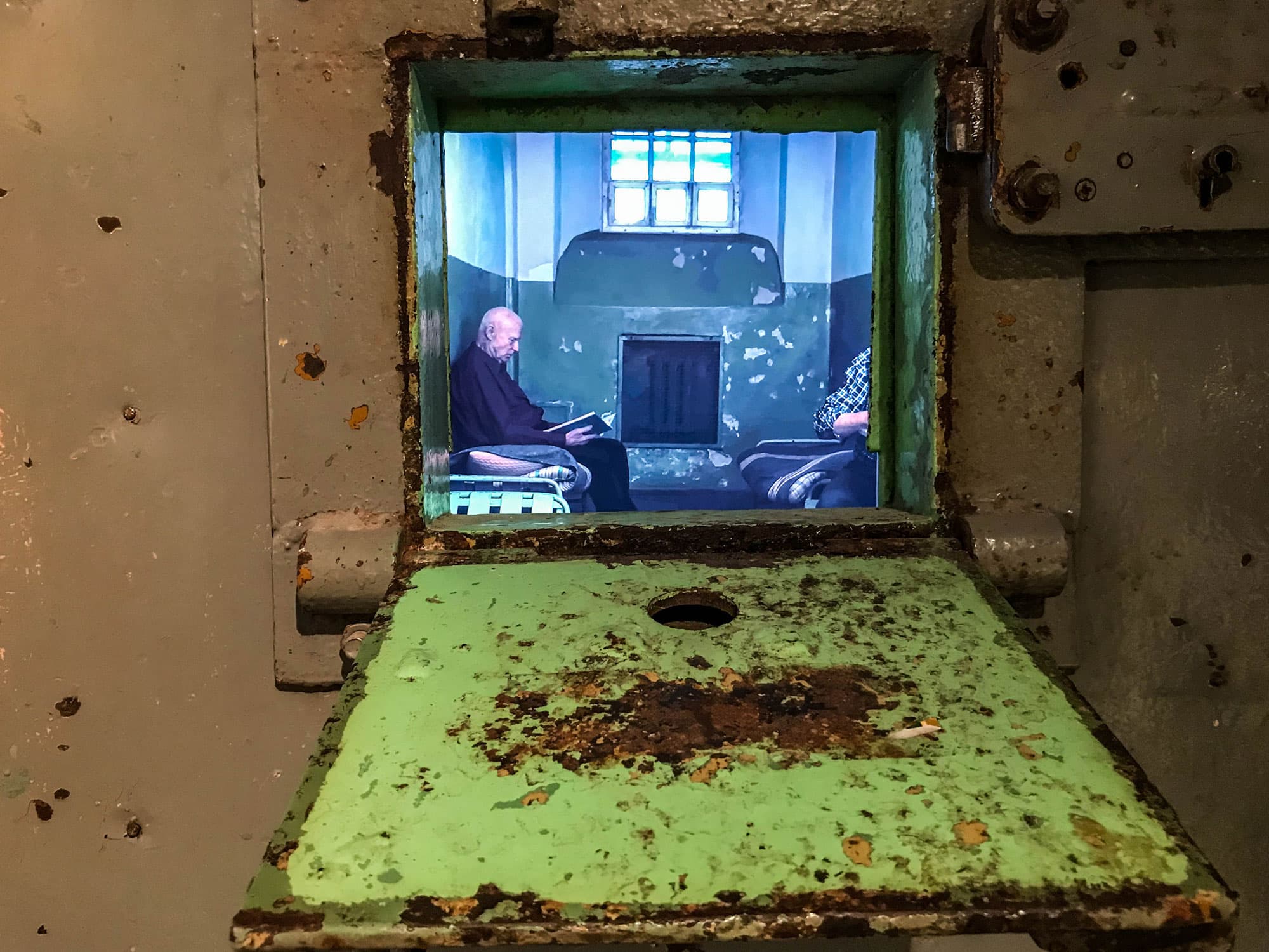 The tiny cellblock window is shown open from a bottom hinge.