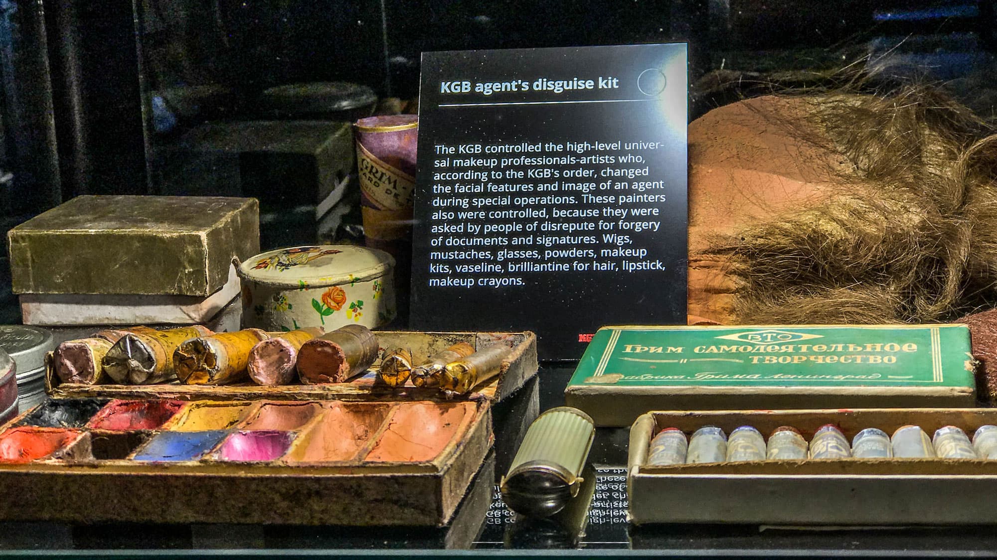 A KGB agent disguise kit is shown with make-up and a wig.