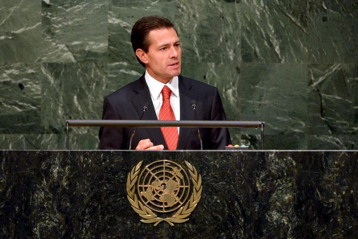 Former Mexican President Enrique Peña Nieto delivers a speech at a podium