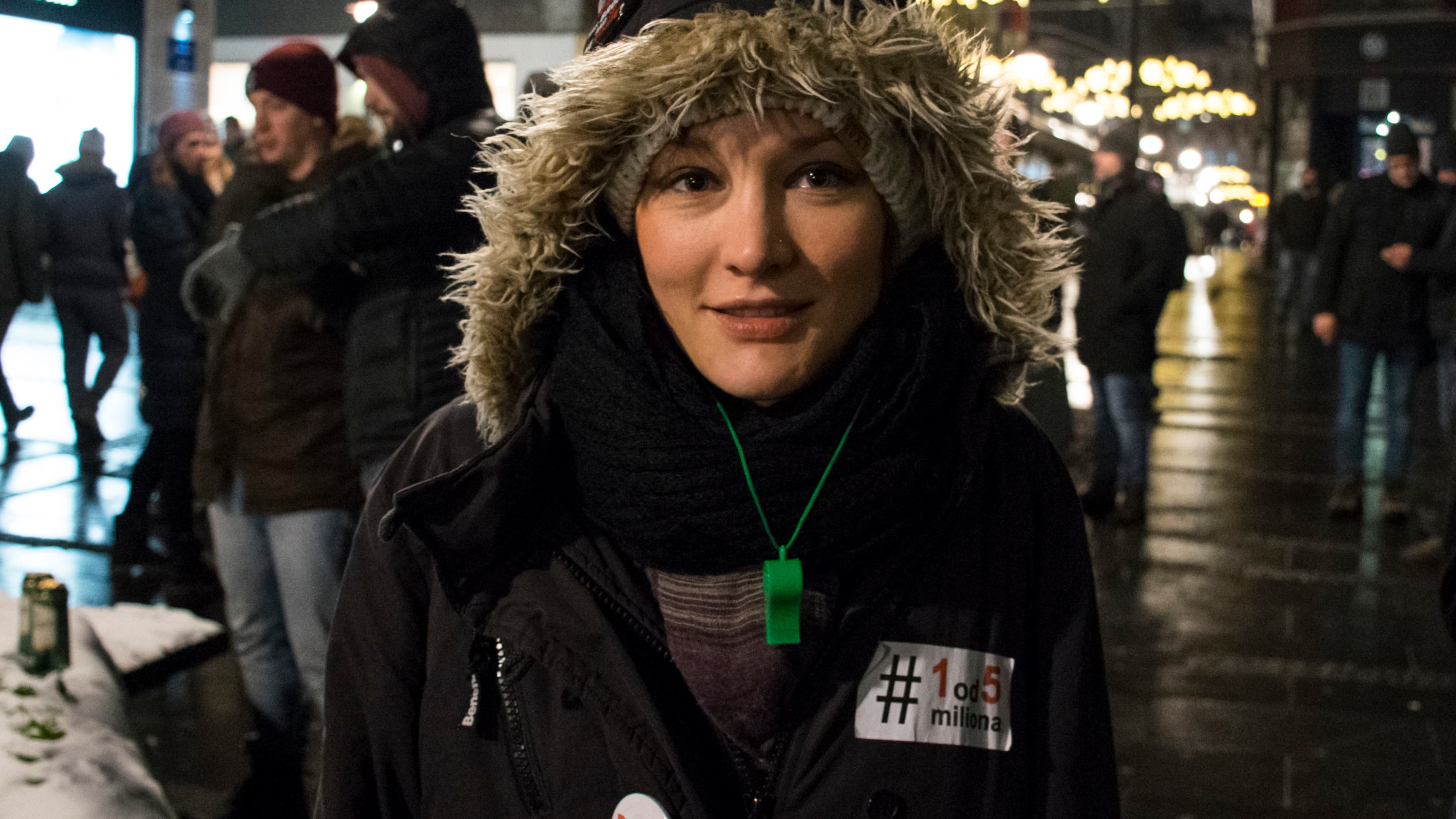 A woman wears a winter coat with a hoodie.