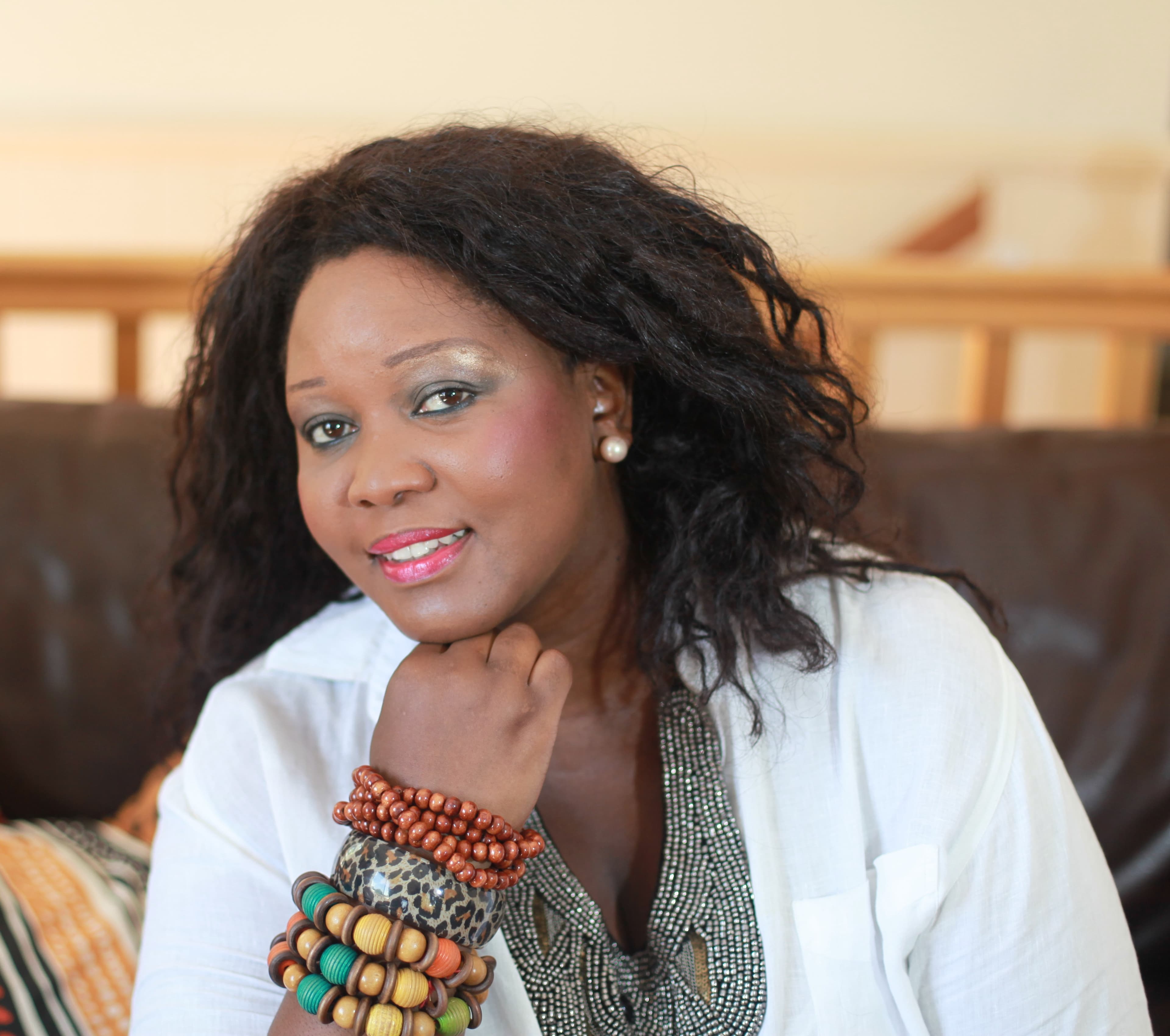 Headshot of an African Australian woman wearing colorful beads.