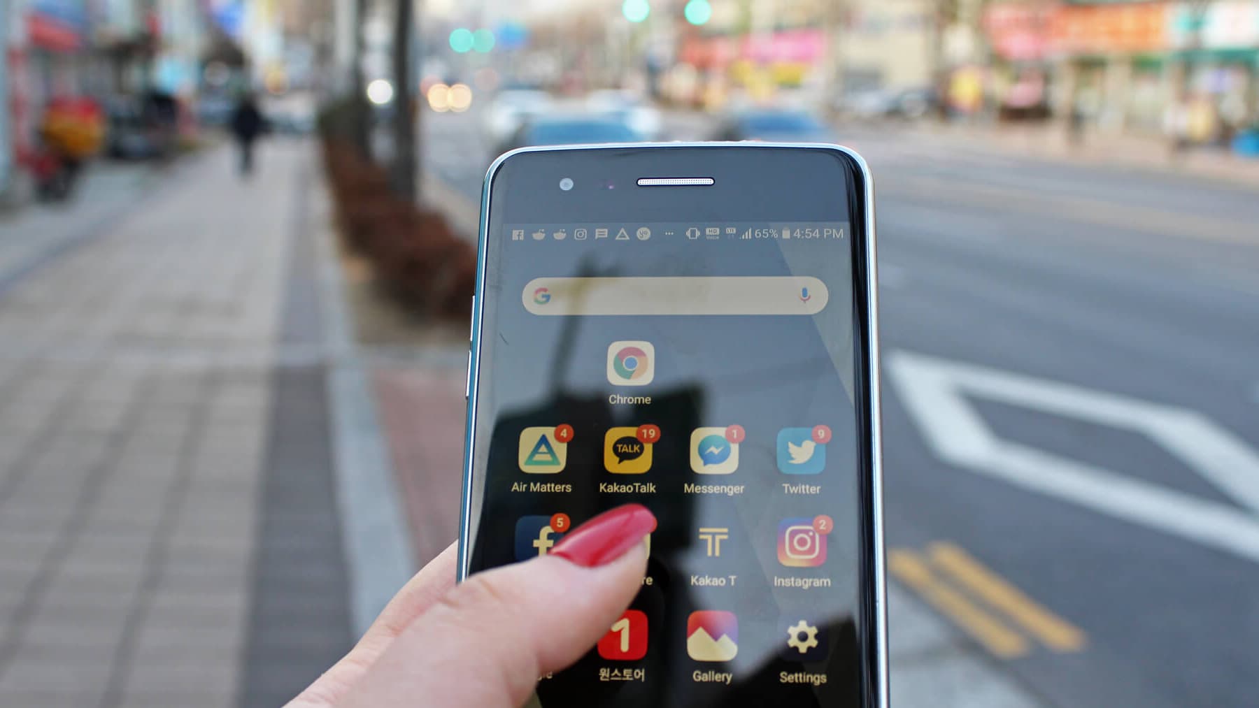 A hand holds a smart phone.