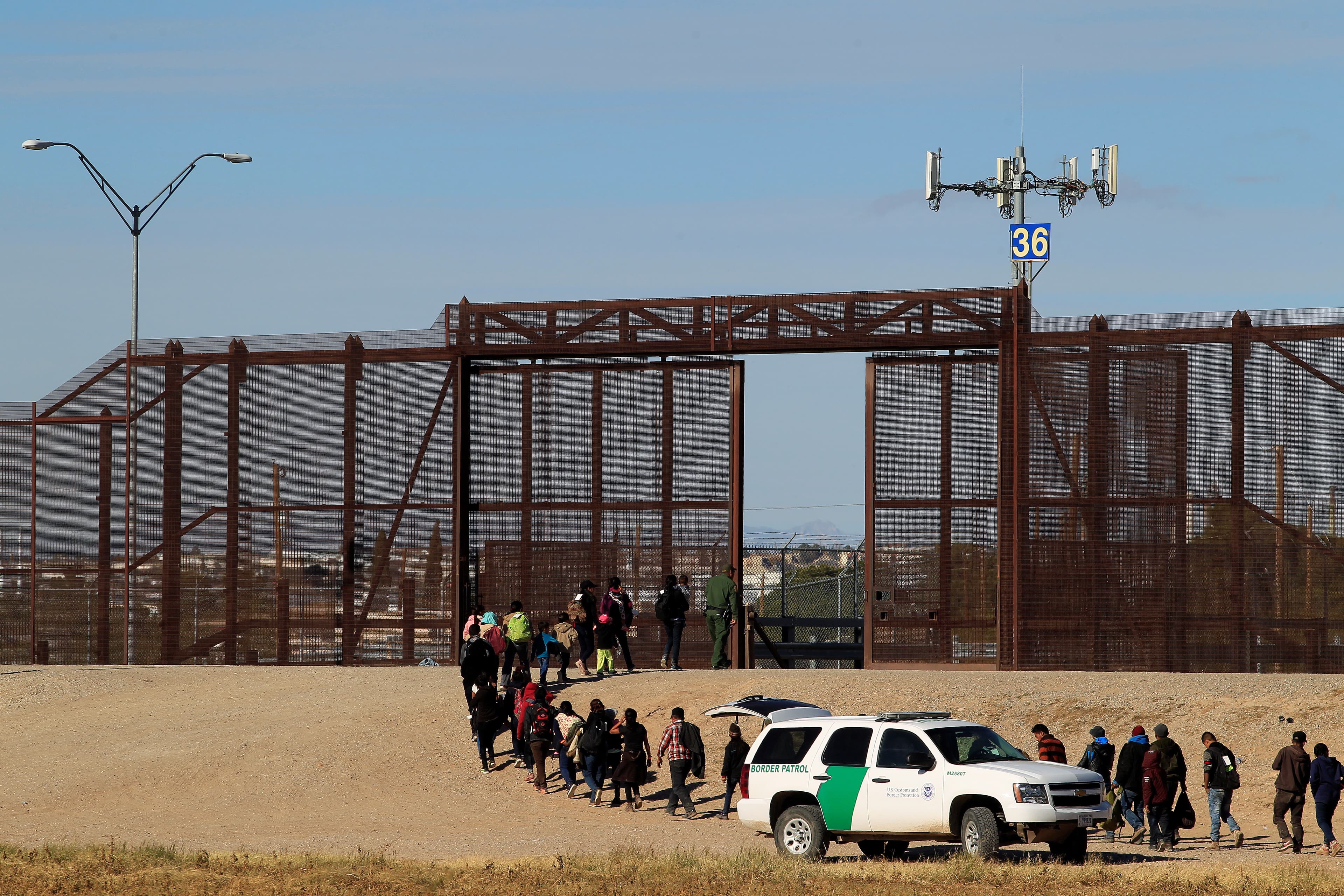 Migrants from Central America are seen escorted by US. Customs and Border Protection (CBP) officials after crossing the border from Mexico to surrender to the officials in El Paso, Texas in this pictured taken from Ciudad Juarez, Mexico.