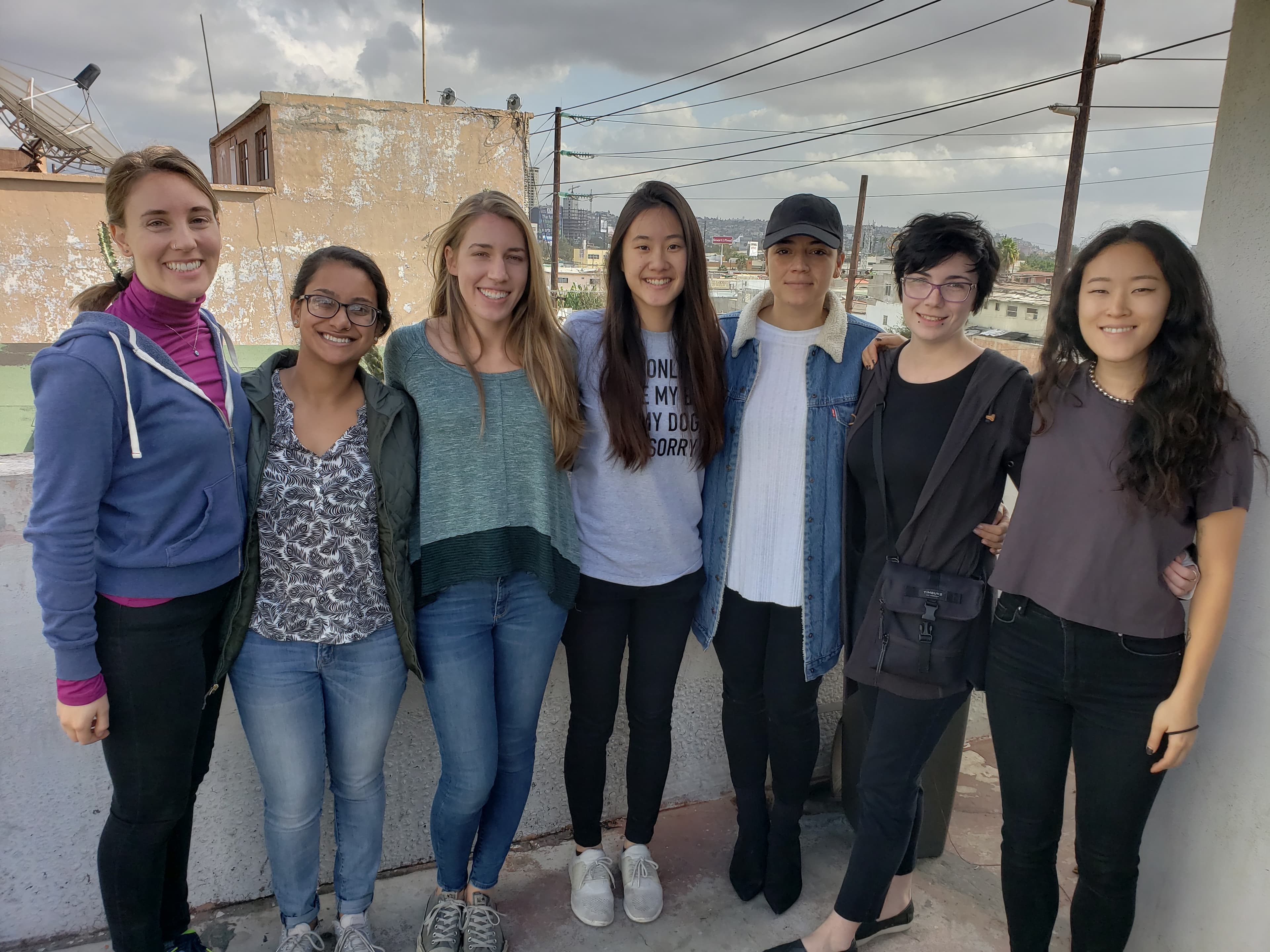 Seven university students pose for the camera