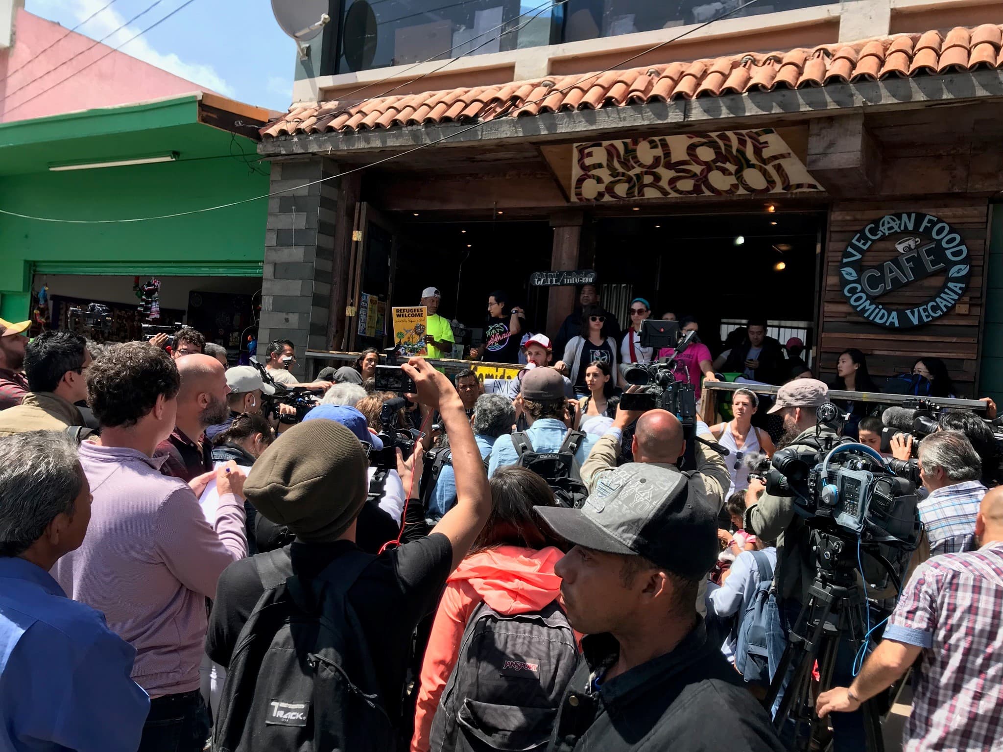 A crowd in front of a cafe