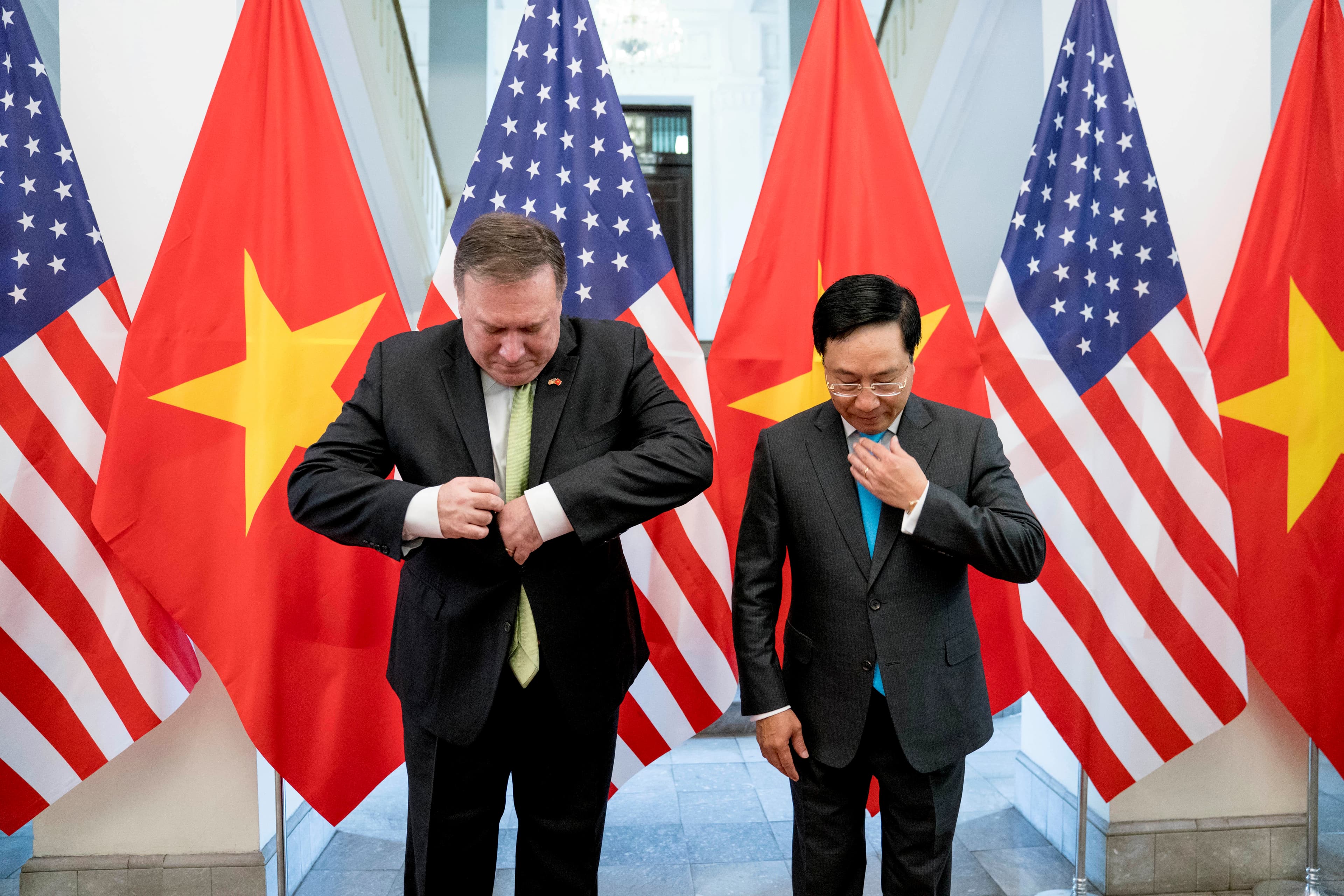 US Secretary of State Mike Pompeo and Vietnamese Deputy Prime Minister and Foreign Minister Pham Binh Minh arrive for a photo opportunity before a meeting at the Ministry of Foreign Affairs in Hanoi, Vietnam, July 9, 2018.