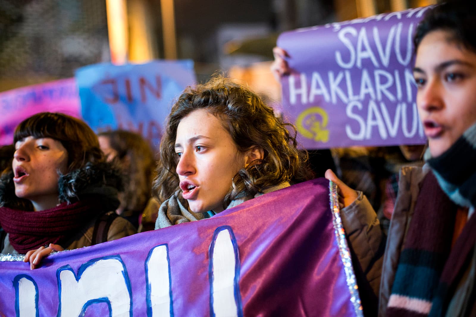Women hold protest signs in a march