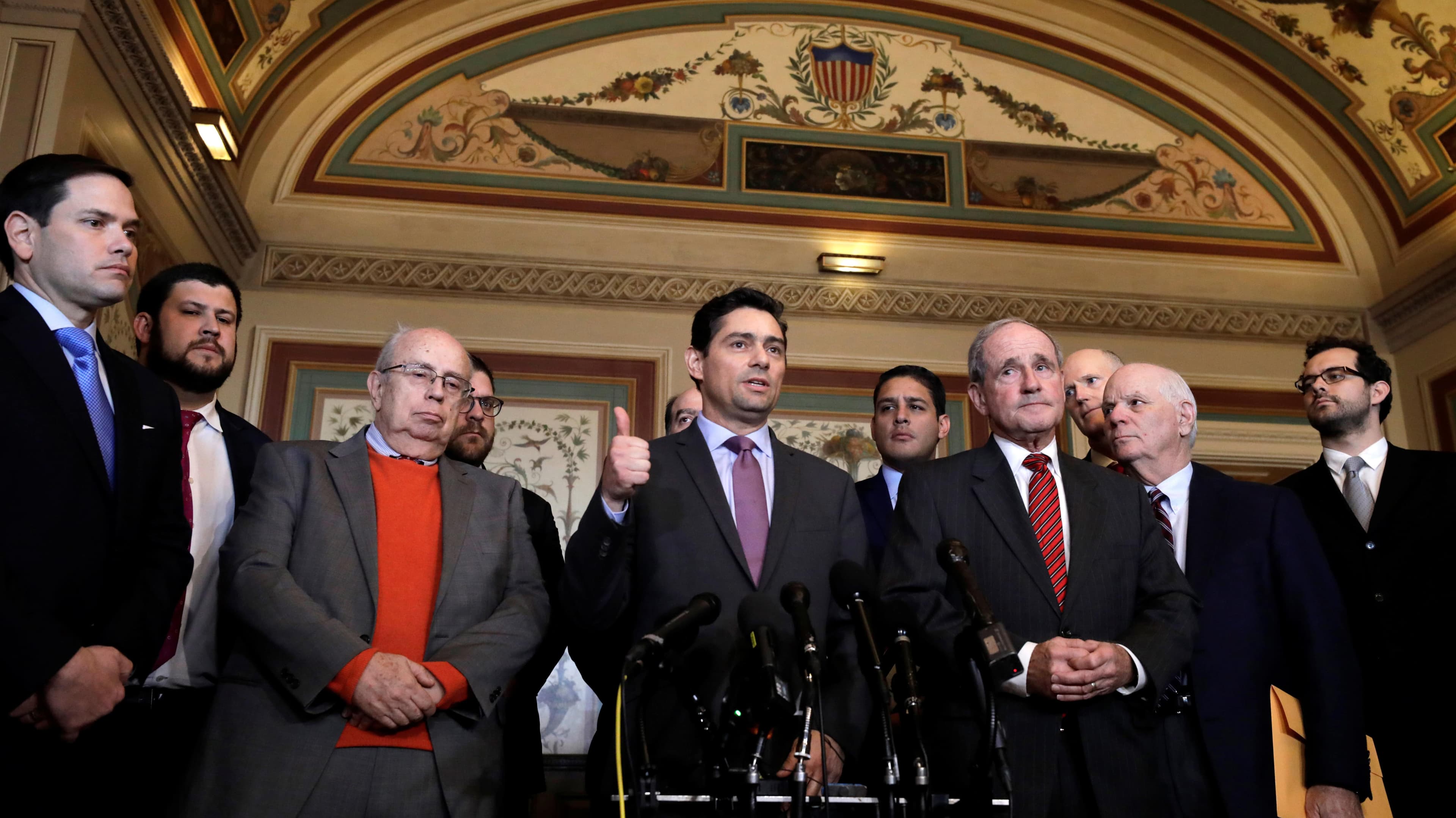 Carlos Alfredo Vecchio speaks at a podium in front of reporters