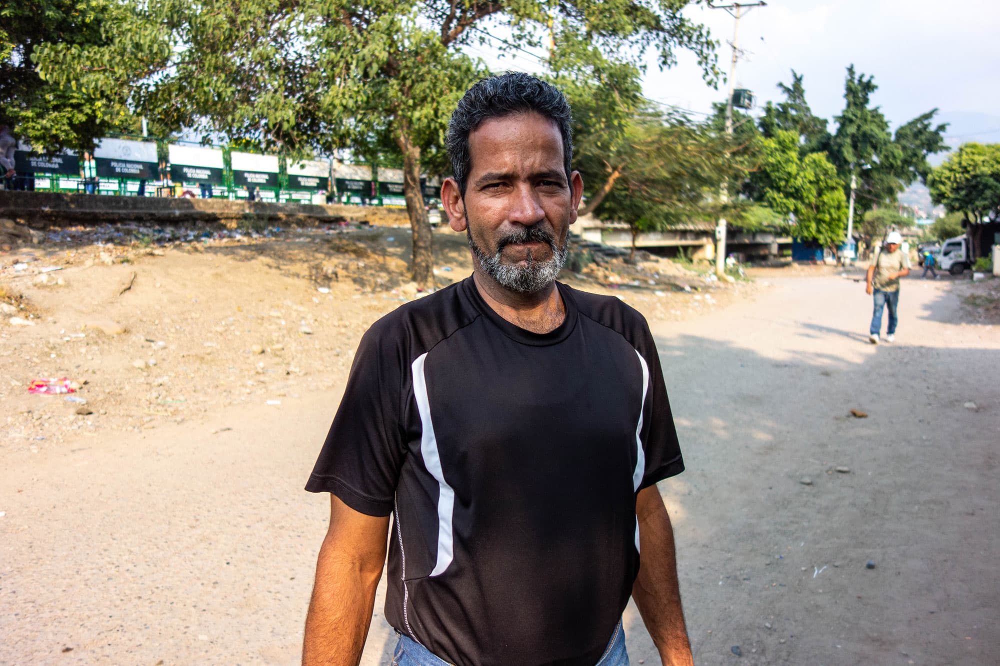An older man wears a black shirt.