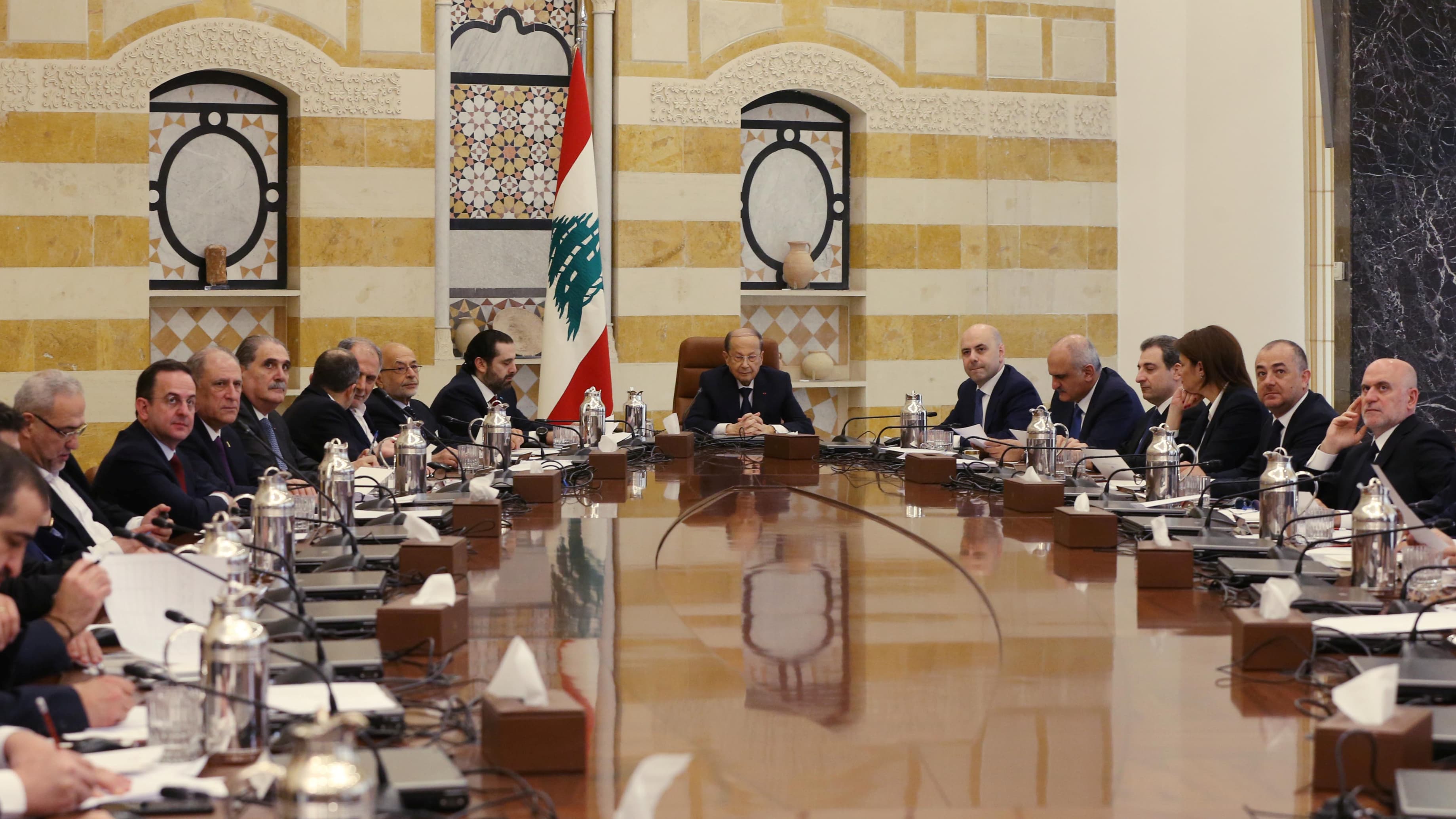 Men sit around a table.