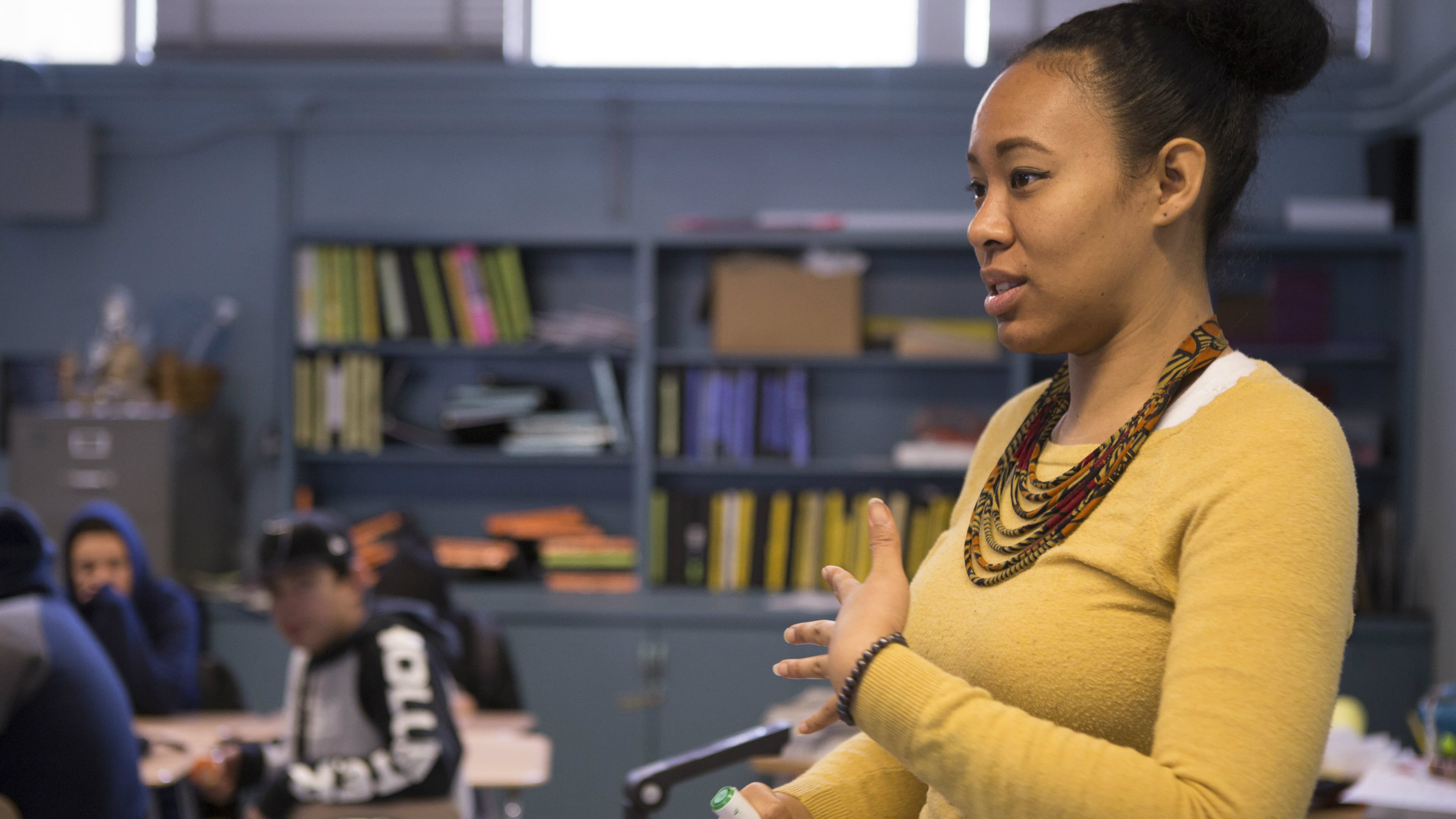 A teacher speaks in front of the classroom.