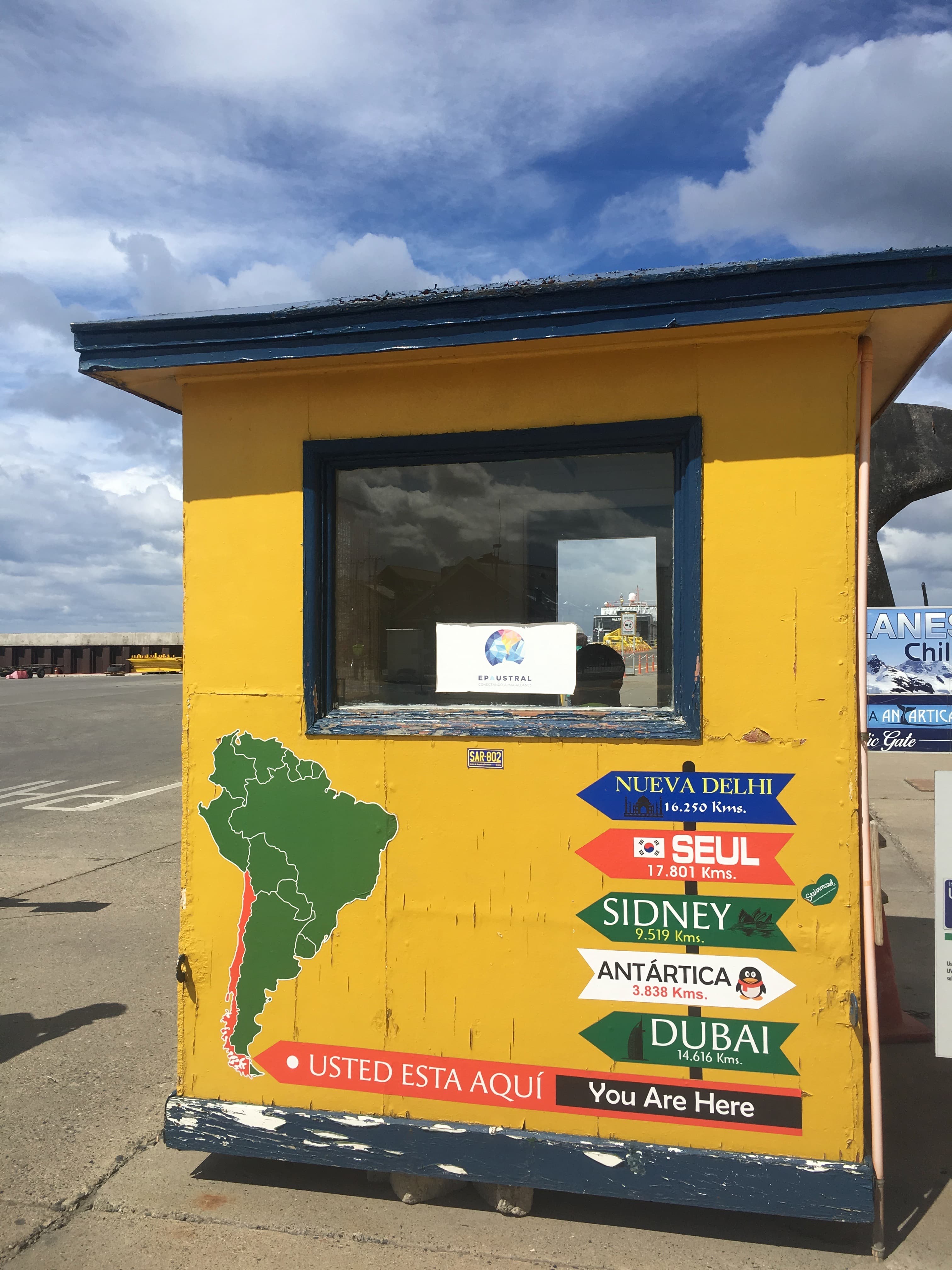 USTED ESTA AQUI-YOU ARE HERE. A map in the port orients visitors. Relevant distance for people headed to the Palmer: Antarctica, 3,838 km, or roughly 2,400 miles.