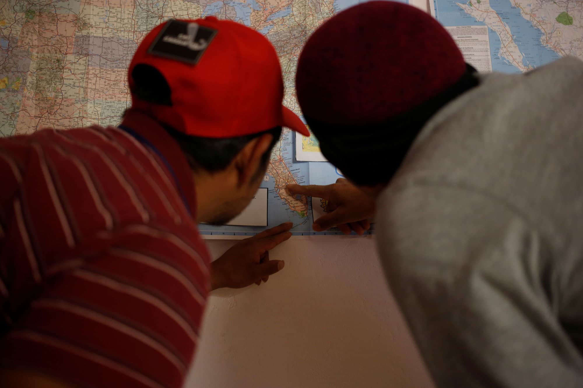 Two boys are shown pointing at a map of the US highlighting Florida.