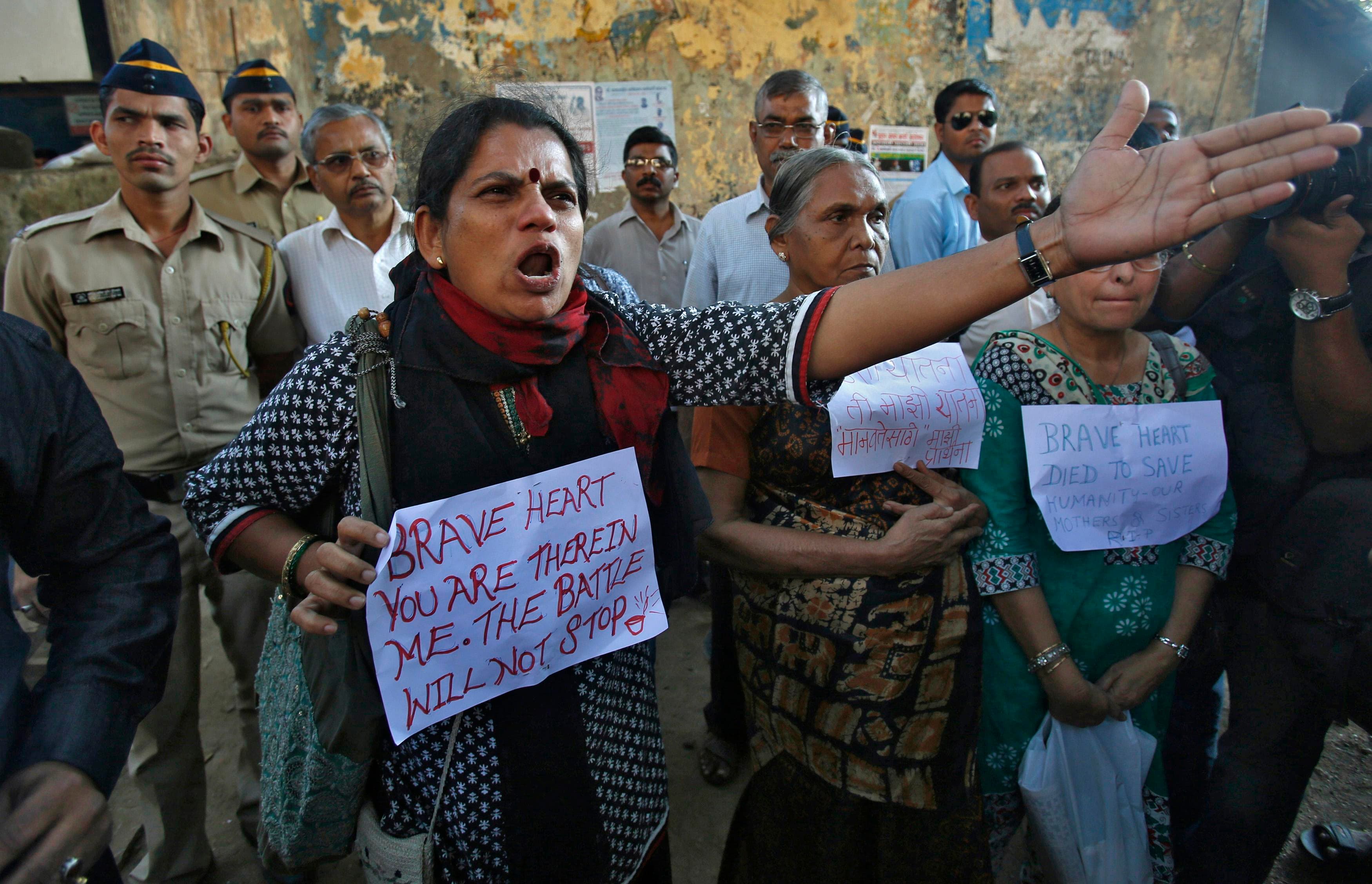 a woman gestures at police officers