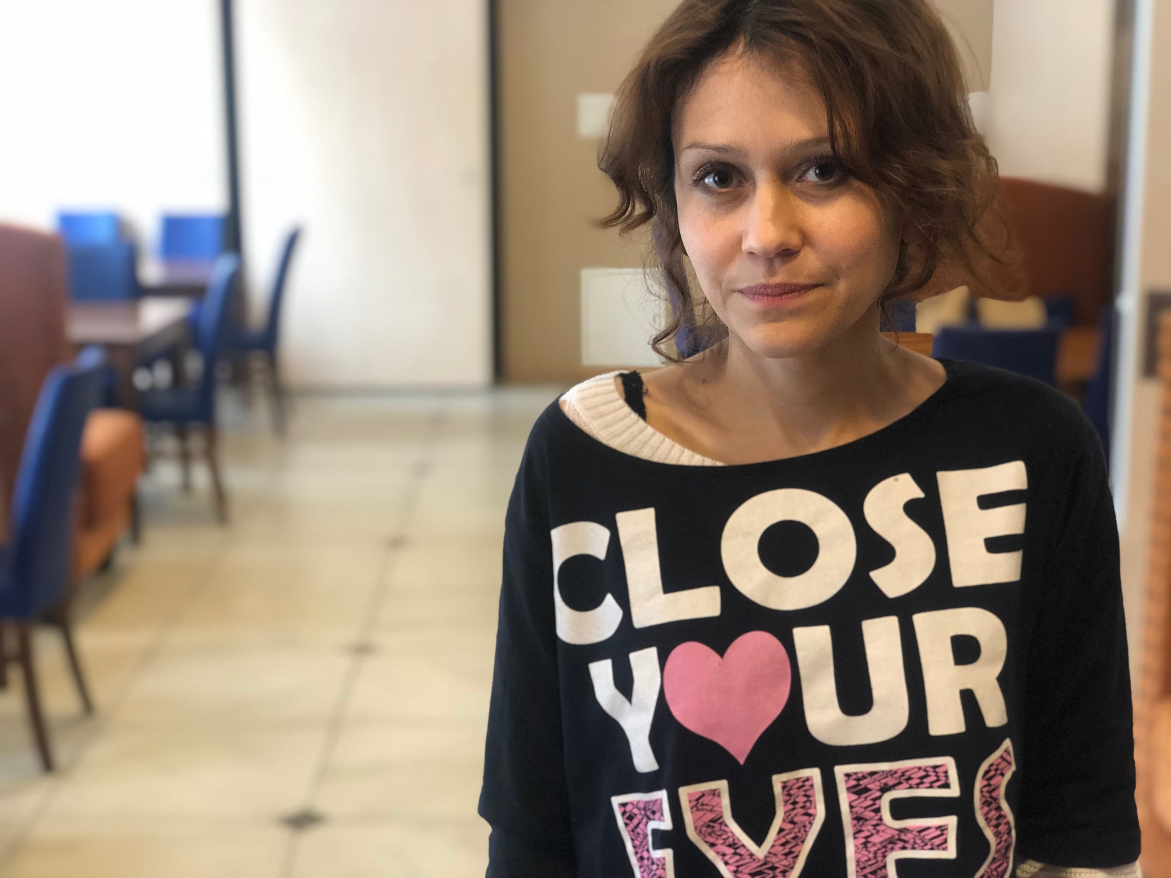 Lyudmila Savchuk stands to the left, wearing a black sweatshirt