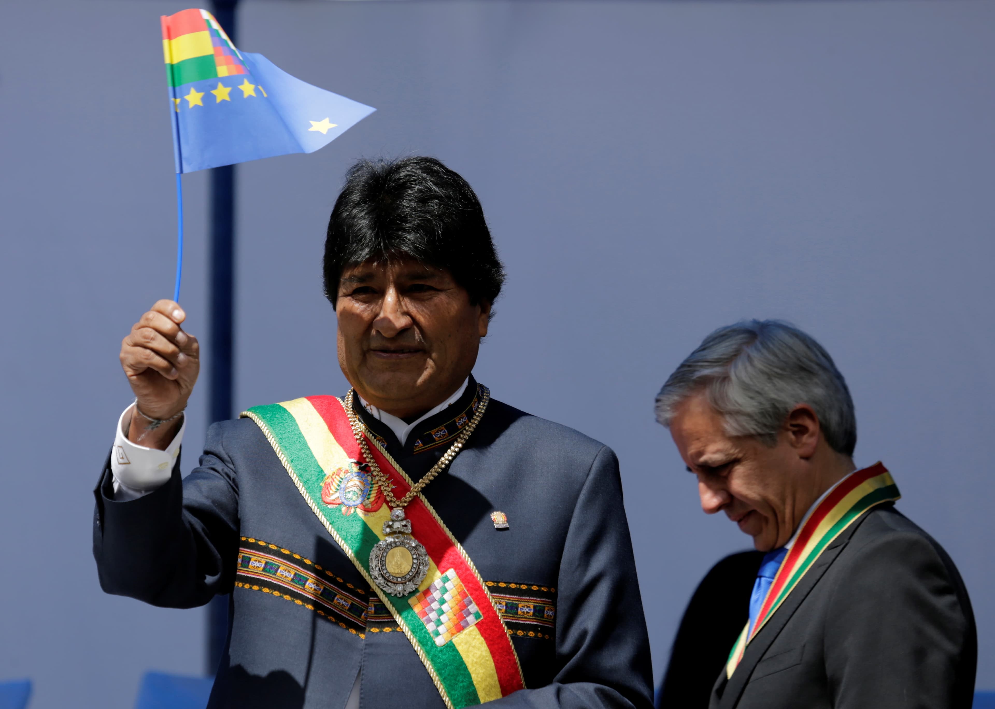 Bolivia's President Evo Morales waives a small Bolivian flag