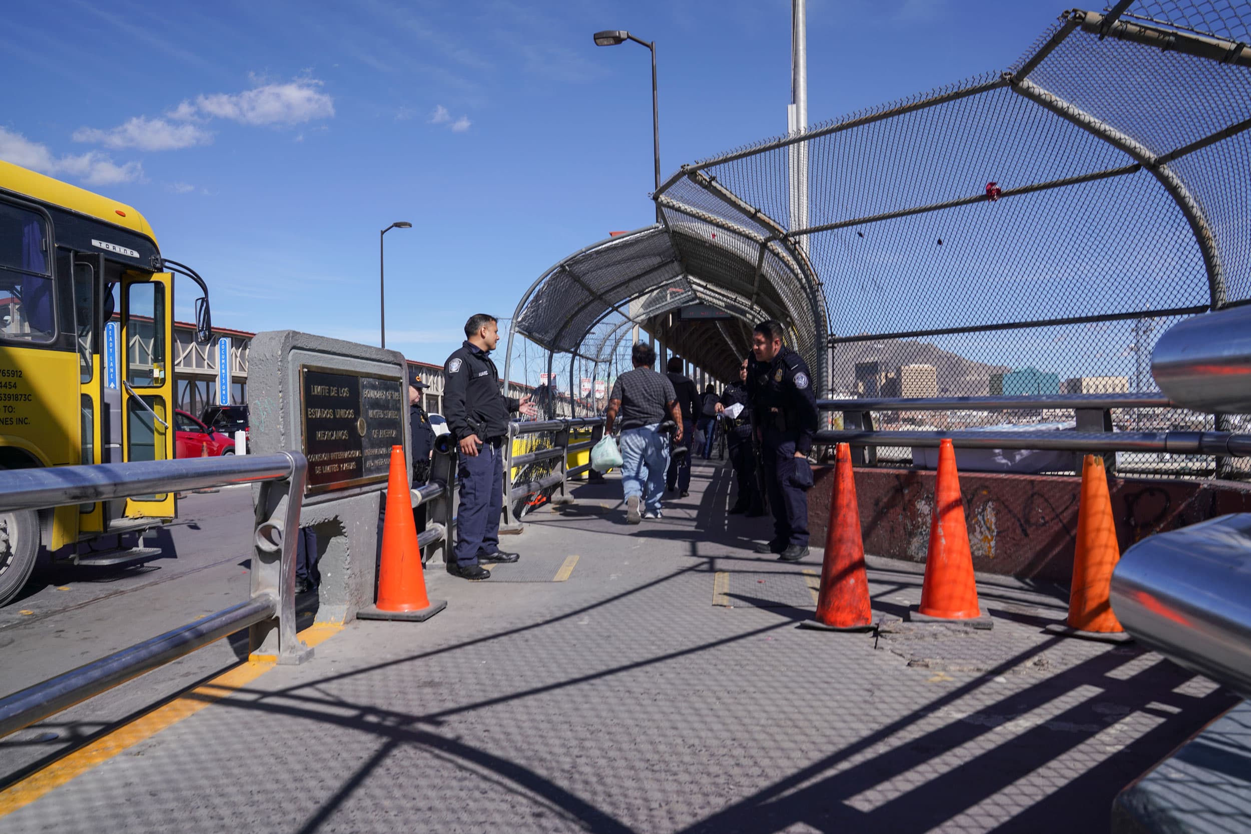 Two Mexican border security officers are show at the entryway to the Mexico-US bordercrossing