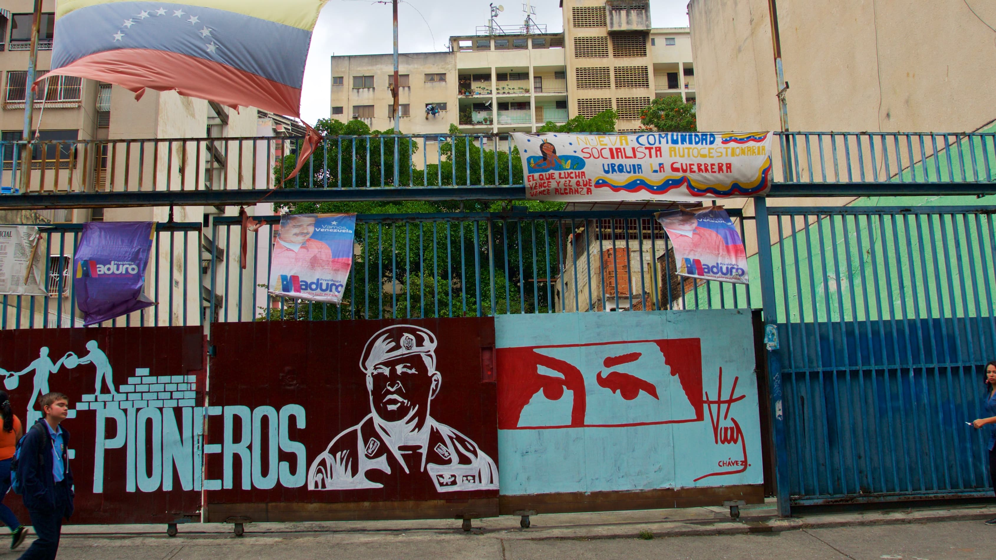 Red stencil of eyes on a turquoise blue background.