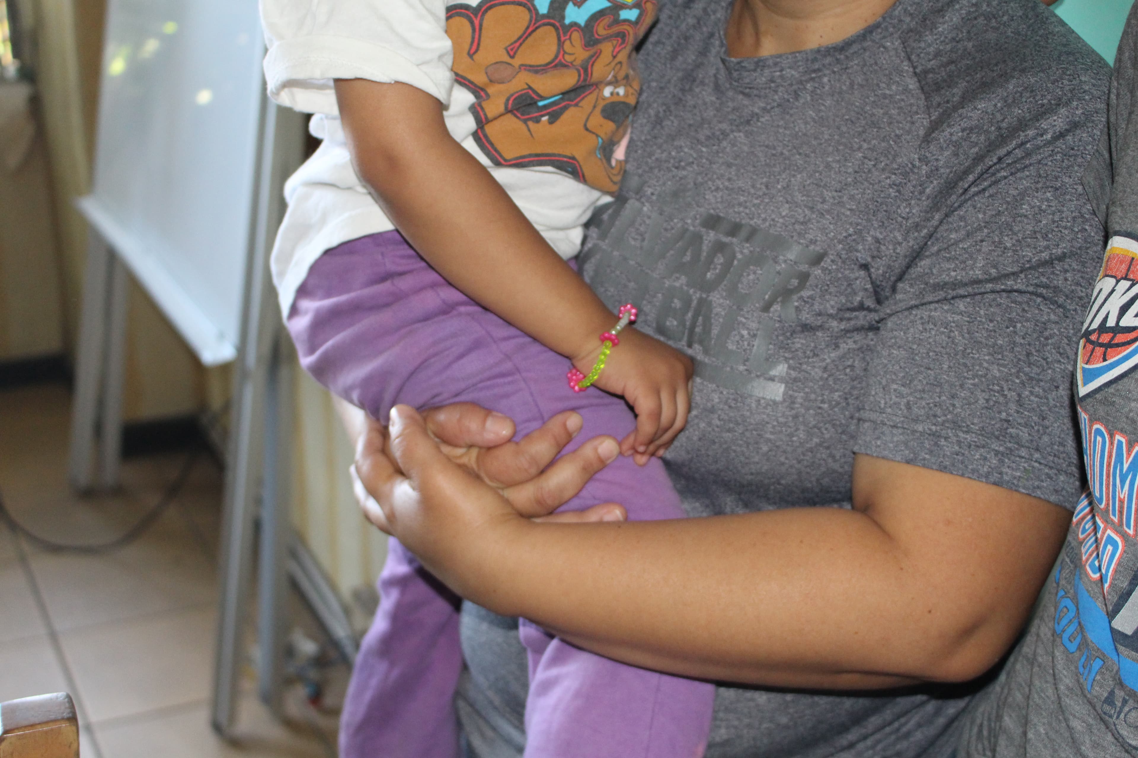 torso of woman holding child