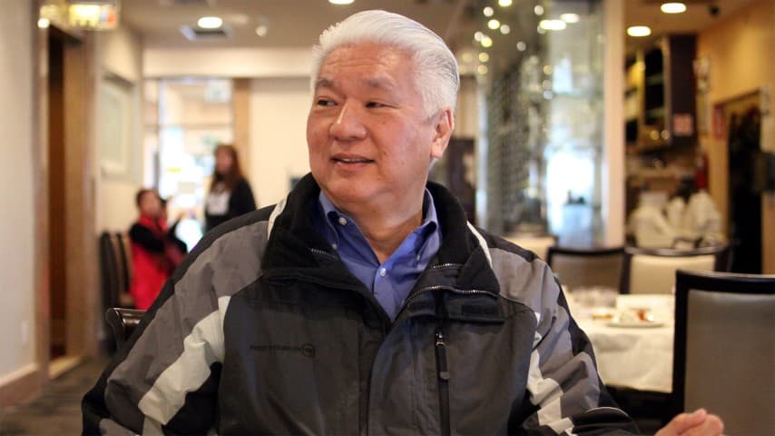 A man sits inside a Chinese restaurant.