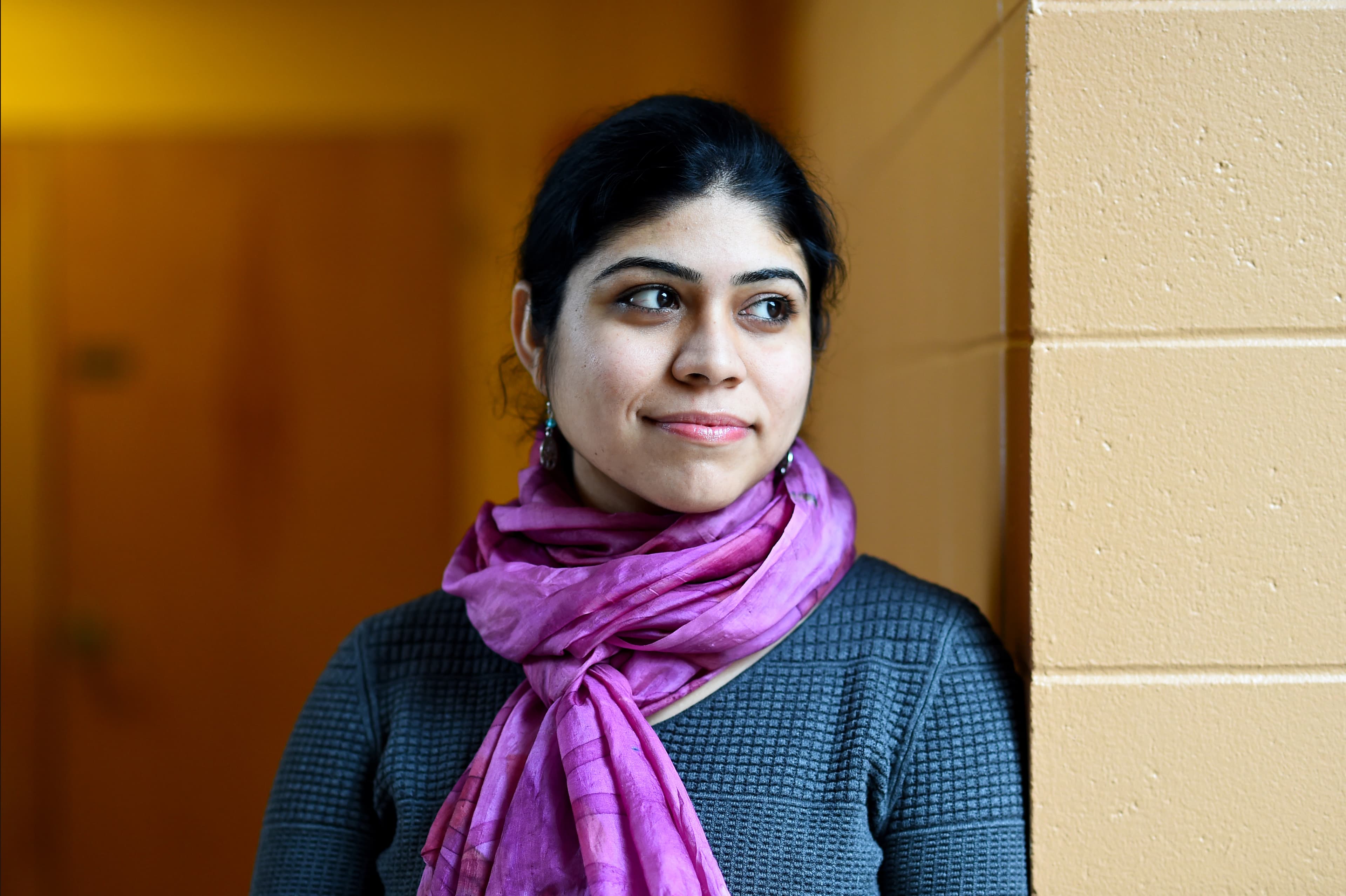 A woman looks to the side.