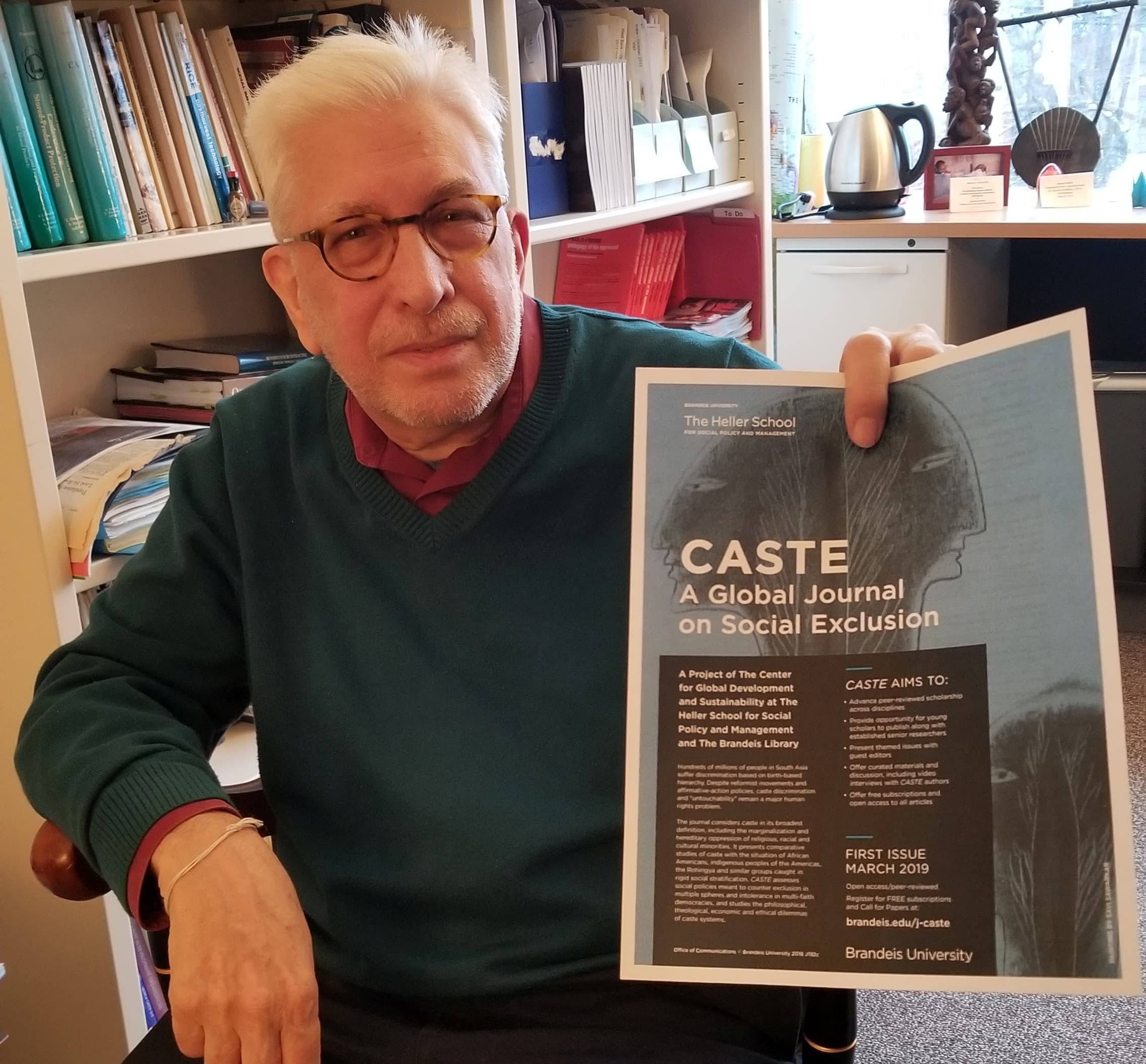 A man holds up a piece of paper.