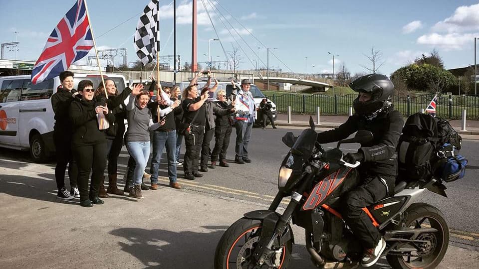Women Riders World Relay founder Hayley Bell arrives at a relay kick-off event in London on her motorcycle, March 9, 2019.
