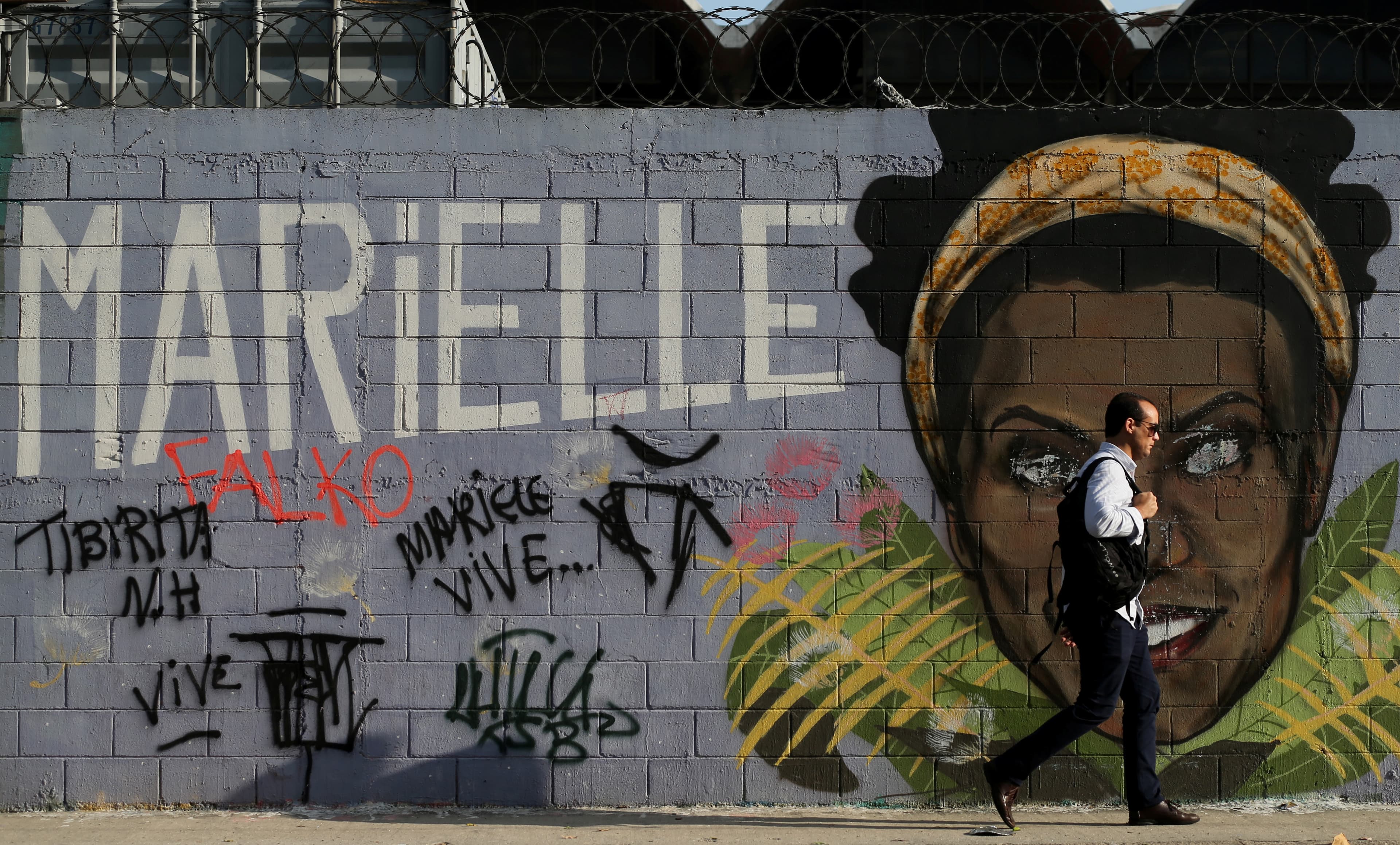Mural of Marielle Franco's face against grey background.