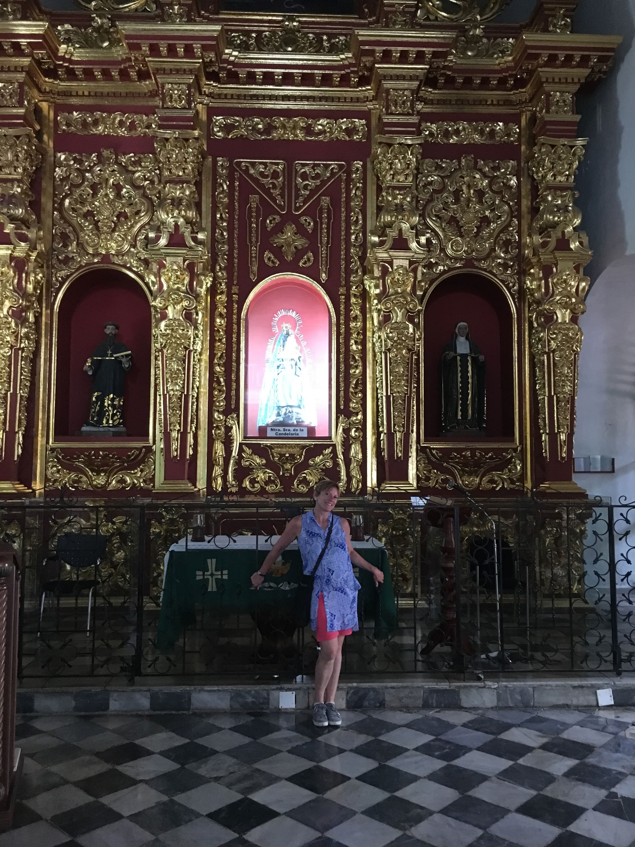 A woman poses in front of a tourist site in Colombia